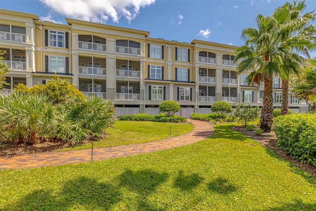 Welcome to this stunning 3-bedroom, 3-bath condo on picturesque St. Simons Island. Located on the first floor, this home offers not only a prime location but also a plethora of amenities that make everyday living a breeze. As you step inside, you'll be immediately captivated by the rich wood floors that flow seamlessly throughout the open floor plan, creating a warm and inviting atmosphere. The heart of the home, the kitchen, boasts granite countertops and an island with a breakfast bar, perfect for both casual dining and entertaining. Relaxing screened in balcony with tile floors and ceiling fan, perfect for sipping your morning coffee and looking out at the natural beauty of the island. The spacious Master suite is a true sanctuary, offering a walk-in closet and a spa-like bath with a double vanity, a luxurious soaking tub, and a separate shower. It's the perfect retreat after a day spent exploring the island's many outdoor activities. Additional highlights of this condo include built-in bookcases, a convenient walk-in laundry room, and a well-appointed pantry, ensuring that you have all the space you need for storage and organization. Living in this gated community provides a sense of security and exclusivity, complemented by covered parking and the convenience of an elevator for easy access to your home. Furnishings are negotiable, making this condo move-in ready and allowing you to start enjoying the St. Simons Island lifestyle immediately.