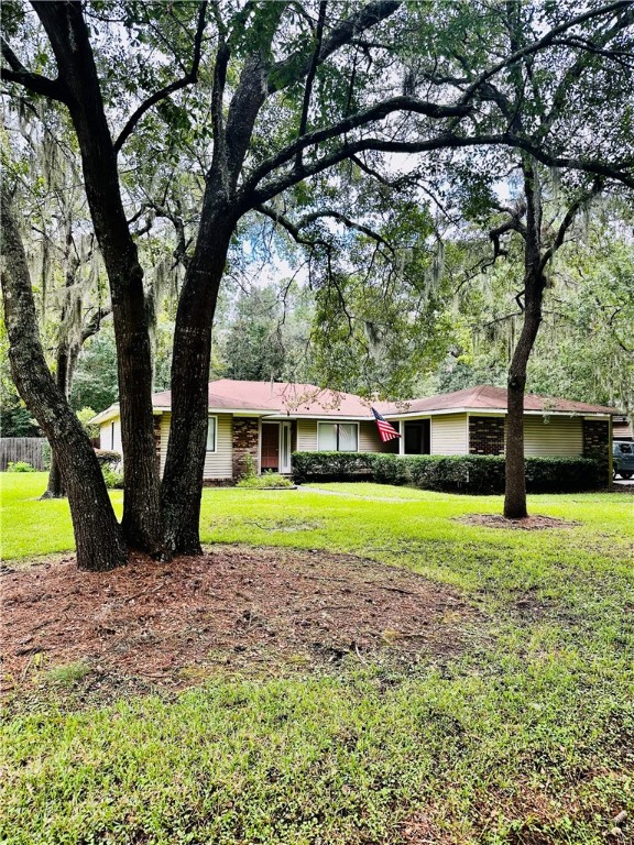 Here is your chance to live in the beautiful ,quaint neighborhood of Sherwood forest. You will not only fall in love with the area, but also the abundance of character and charm of this 3/2 home nestled among the Oaks. LVP flooring ,countertops and appliances were newly added in 2019. The bathrooms also had improvements made in 2019 . Beautiful plank ceilings and lighting make the kitchen /dining area look straight out of a magazine! From the kitchen step into the large living area with wood burning fireplace and new sliders that lead to the open patio and very private back yard. Master bedroom also has sliders that open to the patio and a large walk in tiled shower in bath. Additional storage /workshop with electricity is located off of the carport. This laid back area close to shopping ,FLETC and interstate is just waiting for its new owners so don't wait...come see it for yourself !