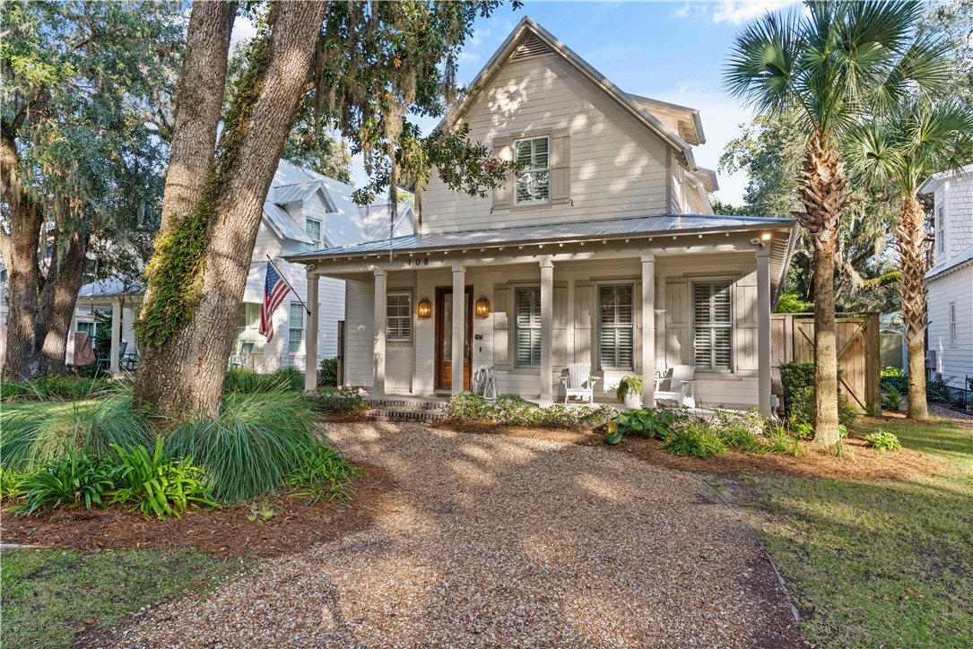 Discover coastal elegance in this Low Country Style beach cottage, blending charm with modern convenience. Perfectly positioned near the beach, shops, and dining, this turn-key gem is ideal for both serene retreats and rental potential. Its captivating curb appeal showcases covered porches and a classic design. Inside, the space radiates warmth with coffered ceilings, oak flooring, shiplap accents, plantation shutters and a sunlit atmosphere. The gourmet kitchen stands out with its large island, spacious cabinetry, and separate cooling units. The primary bedroom on the main level promises relaxation with French doors opening to the backyard oasis, a generous walk-in closet, and deluxe bath. Additionally, find a handy laundry room and two upstairs en suite bedrooms. The backyard is a haven, highlighted by a pool with a spill-over spa, astroturf, and a covered outdoor kitchen, perfect for relaxation or entertaining. The property also offers promising rental potential. Experience this beautiful coastal treasure!