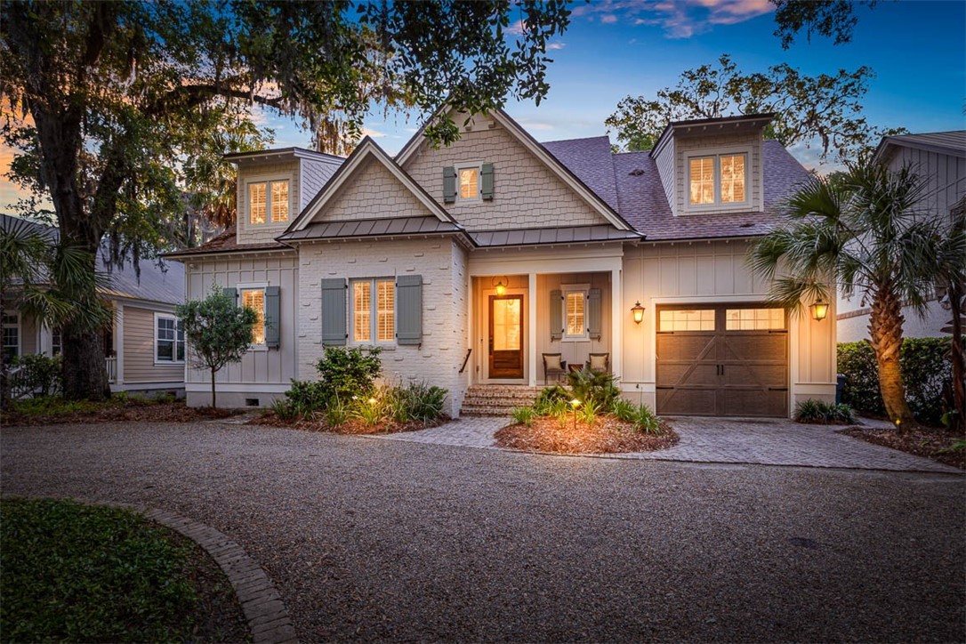 LOCATION.. LOCATION... LOCATION !! Village Oaks is among the most charming neighborhoods St. Simons Island has to offer. Situated on the South end, this home is in a very private area while also just steps from the Pier Village, beach and some of the best local restaurants in town. This custom 5 bedroom/4.5 bath home built in 2019 has amazing curb appeal with tons of character and upgrades, inside and out! Upon entering, you walk into the open floor plan that includes the great room with plenty of room for family gatherings or entertaining, a gourmet kitchen, and dining area. From the Great Room, step through the beautiful french doors of the glassed in sunroom that includes an additional fireplace and eye catching finishes such as a unique cork wall, a gorgeous wood ceiling and custom brick flooring. Downstairs you will also find the primary bedroom that includes a spacious bathroom with separate soaking tub, dual vanities and very large shower. No detail has been overlooked as other swoonworthy features of this spectacular home include stainless steel appliances, quartz countertops and hardwood flooring throughout, wood burning fireplace, shiplap walls, crown molding, large bonus room that allows enough sleeping for seven people, herringbone paver accents adding rich beauty to much of the exterior entry and seating areas, as well as the floor to ceiling brick accent wall and hearth on the great room fireplace ...there is even a built in dog kennel, home generator AND comes completely furnished. The pictures are great but it looks even better in person so don't miss your chance to see this little slice of heaven before its too late!
