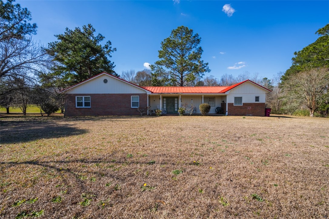 Once in a lifetime offering! Over 289 acres spread over Bacon and Appling County. Farm consists of 2 Bed and 2 -1/2 bath remodeled main house and a 2007 32x66 mobile home (currently used as a rental). Main house has formal dining, built in cabinetry, office space, eat-in kitchen, oversized laundry and pantry, and large living area- all open concept. Has gas appliances and instant heat tankless hot water. Oversized master bedroom has custom cabinetry and walk-in closets. 1000 gallon propane tank and private well on property. Property is divided by the Big Satilla Creek and consist of rolling hills, hay fields, wetlands, and hardwood forests. Only 30 miles from Jesup, this is truly a hunters paradise. Hunting and riding trails throughout. Plenty of land for a family compound or to further subdivide into smaller tracts. Roughly 142 acres of wetlands surrounding the Big Satilla Creek and around 147 acres combined “high” ground throughout the farm. Parcel ID for Bacon County is 057 092001 and in Appling County parcel ID is 0055 011.