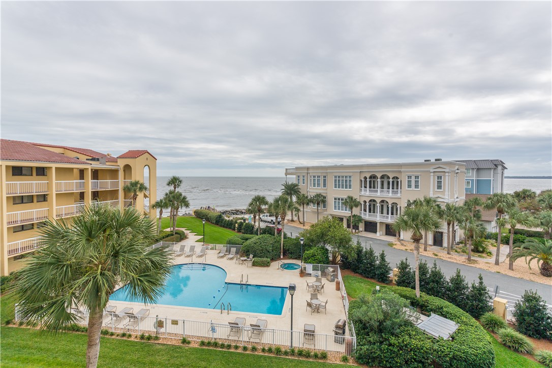 Nestled along the pristine shores of St. Simons Island, behold a rare gem - a top-floor condo offering the pinnacle of coastal living. Welcome to your sanctuary in the sky, where gorgeous ocean views and luxurious amenities await. This exclusive 2-bedroom, 2-bathroom condo spans a generous nearly 1200 square feet, boasting a layout designed for both comfort and style. As you step inside, you're greeted by the warmth of a fireplace, inviting you to unwind in the embrace of flickering flames while enjoying the calming sounds of crashing waves just outside. Bask in the beauty of the Atlantic from your private oceanfront balcony, where every sunrise paints a masterpiece across the horizon. Inside, vaulted ceilings in the living room create an airy ambiance, accentuating the open floor plan living space. Beautiful updated kitchen includes stainless steel appliances and abundant storage space. The primary bedroom offers a serene retreat with balcony access and an ensuite bathroom featuring a double vanity and a newly remodeled, enlarged oasis of relaxation. Convenience meets efficiency with an on-demand water heater and a large washer/dryer capable of accommodating comforters and linens. Additional features include new hurricane-proof sliding glass doors to the balcony, attic access for extra storage, and recent exterior updates such as newly painted rails and walls, new non-slip tile floors, and a refreshed roof. For added convenience, enjoy an assigned parking space conveniently located by the elevator, with a storage closet nearby. Plus, indulge in the resort amenities of the prestigious King and Prince, ensuring every day feels like a vacation. Oceanfront heated pools at the resort and one oceanfront pool with BBQ grill and a hot tub at the South Villas building perfect for outdoor gatherings. Additional amenities include fantastic dining options, tennis courts and fitness center, seasonal activities and classes, and occasional live music. Don't miss this opportunity to experience coastal living at its finest. Come home to King and Prince South Villa Condo, where every moment is a seaside escape.
