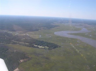 Commercial property adjoin the 4000' Eagle Neck runway near the marshes of the South Newport River. Access to the Atlantic Ocean either to the North of St. Catherine's Island or to the South through Sapelo Sound between St. Catherines Island and Blackbeard Island are natural deep water channels. The Inter-coastal Waterway (ICW) is close by as well. Property features two 48'x 48' hangars, a 60'x 60' hangar with shops and additional office,  T-hangars with a small office, a double wide manufactured home and 677' of road frontage. Developer has improved paved surfaces and adjoins aviation fly in community with runway access to 4000' paved lighted airstrip