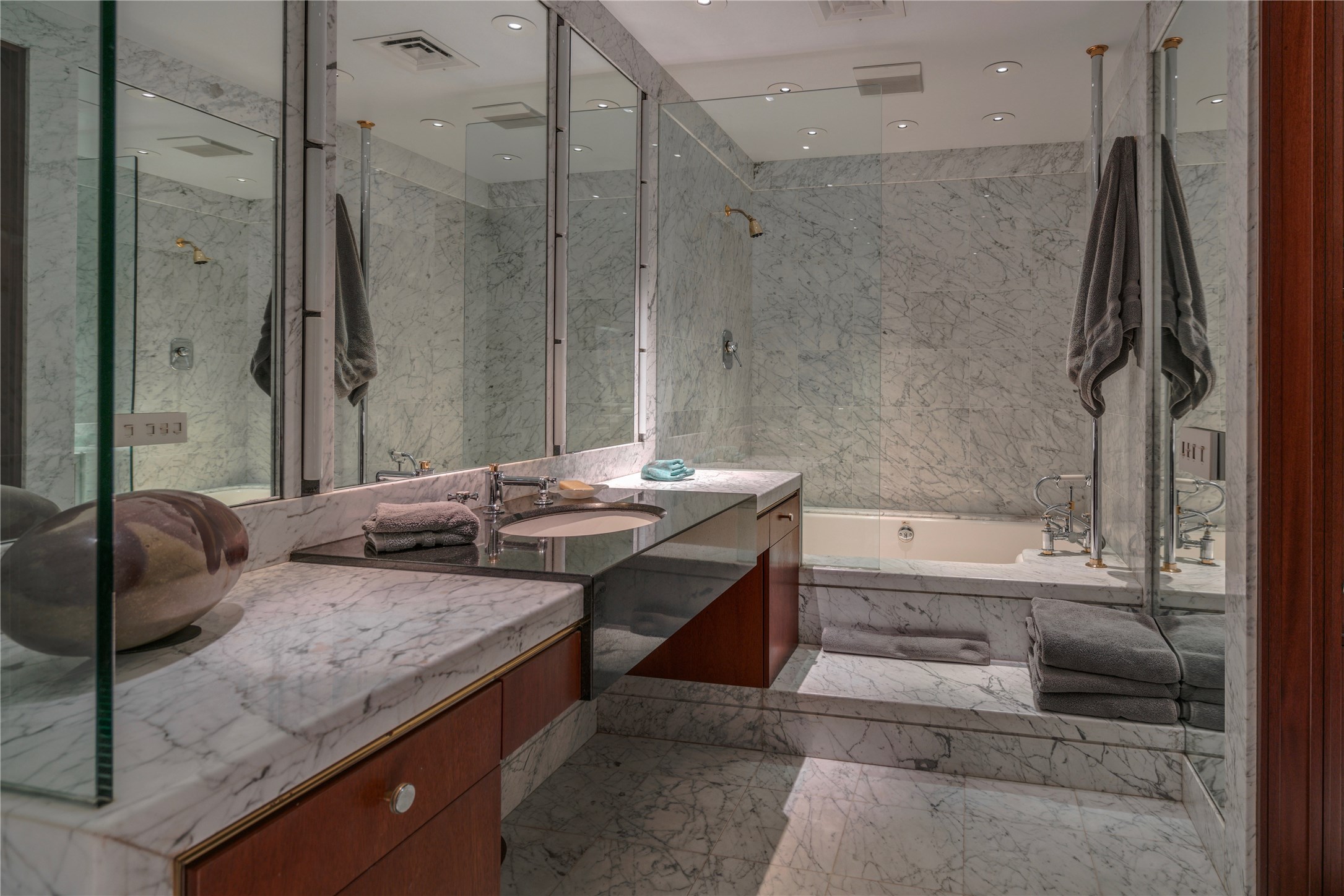 Slabs of floor to ceiling white Carrera marble trim marble walls and shower in 12