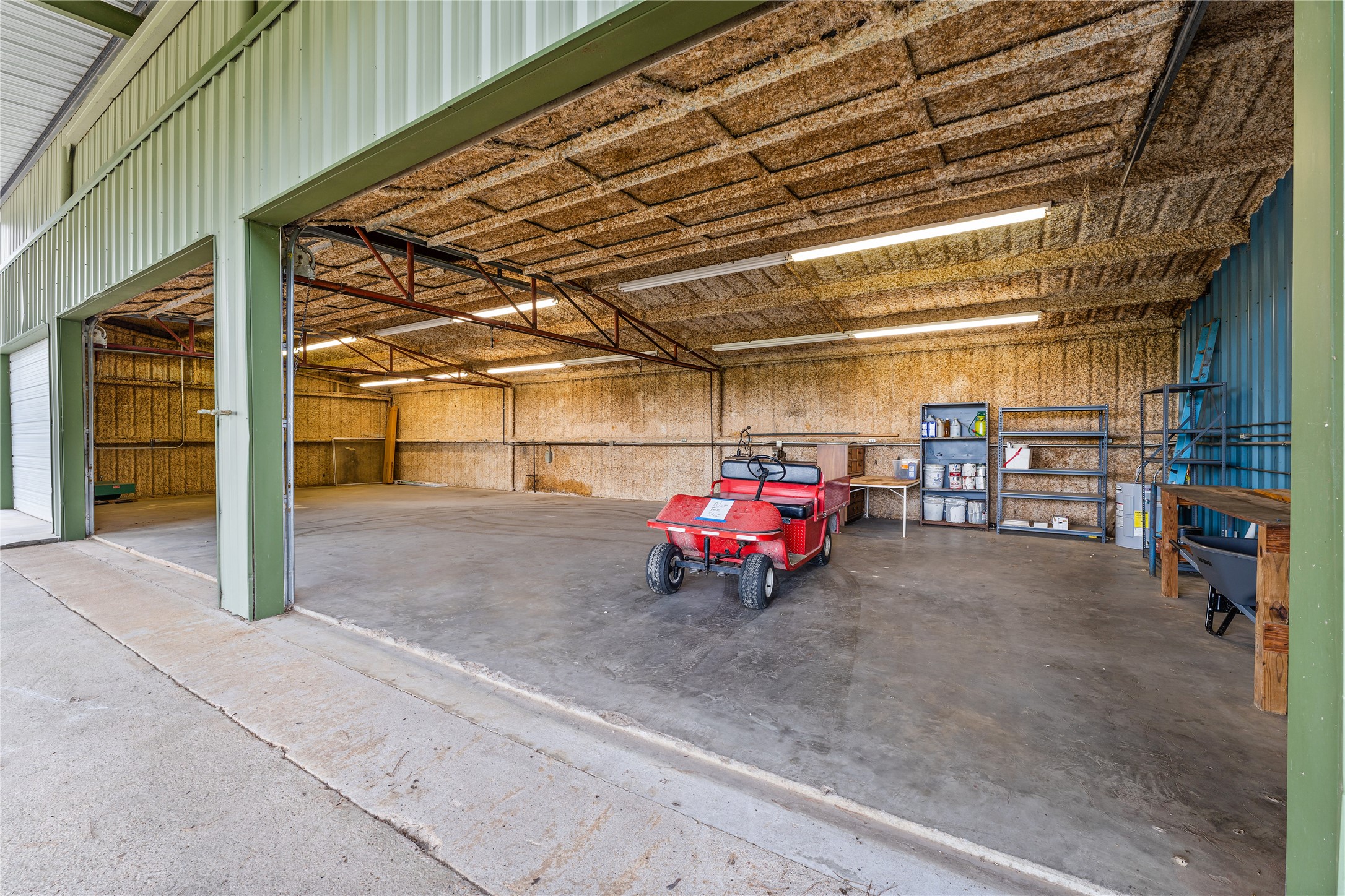 The property features a 2187sf fully insulated barn/workshop large enough for your classic car collection, or a Barndominium.  The red wagon does not convey.