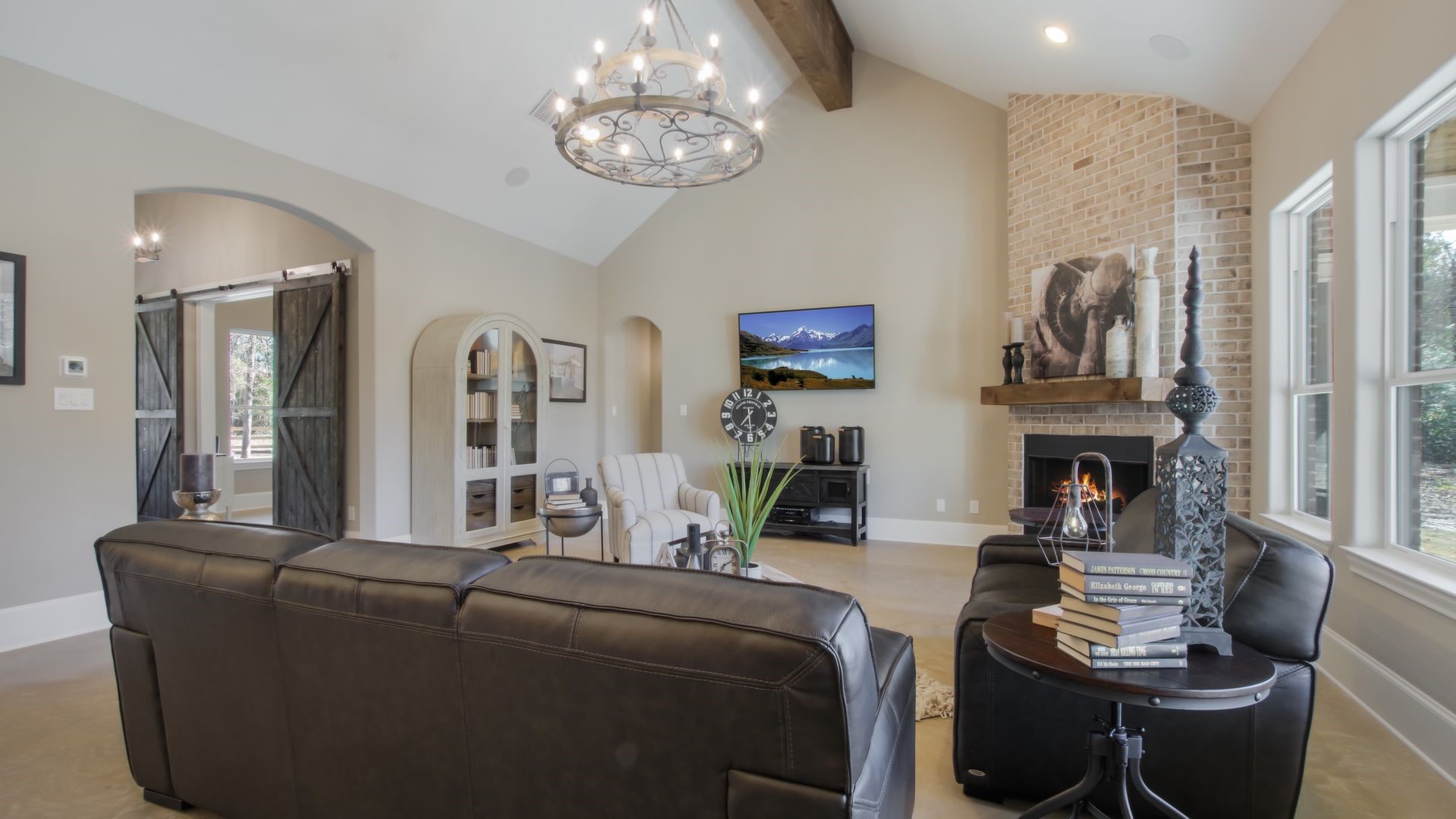 As you enter the residence the custom touches just pop.  Home office/study with brick accent wall is to the left featuring large sliding barn doors.  All open to the living room and view of backyard.