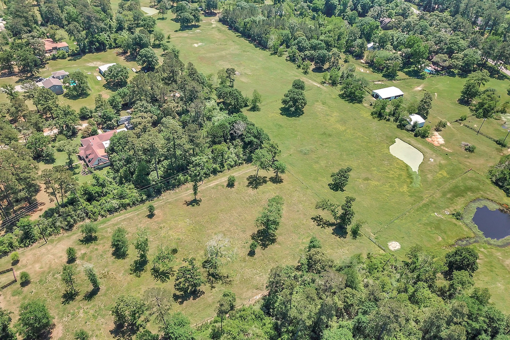 Birdseye view of fenced 3 acre tract showing additional acreage behind this tract also for sale. Please contact listing agent for more details.