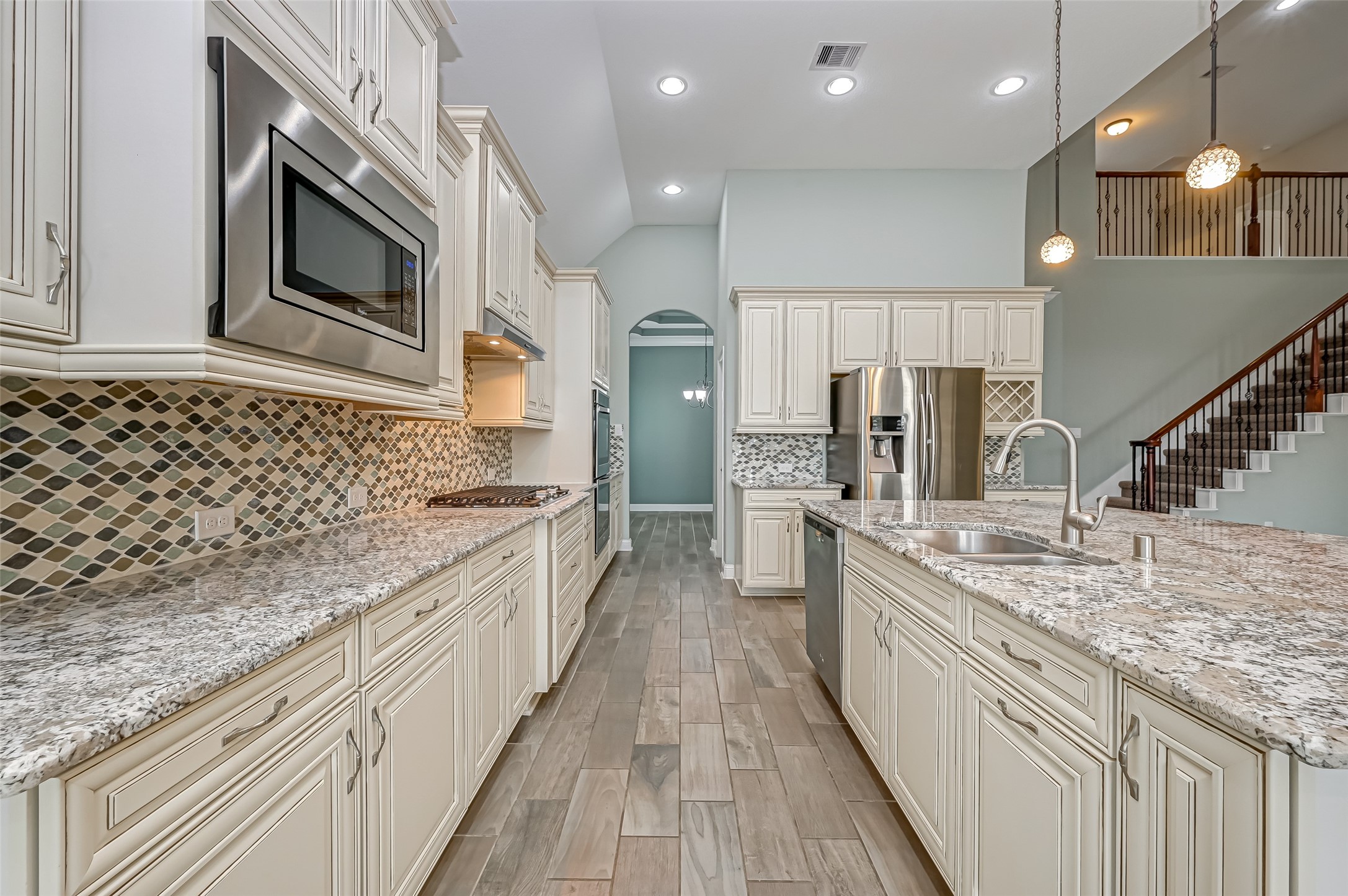 Kitchen features cream cabinets with granite countertops and stainless appliances for that timeless feel.