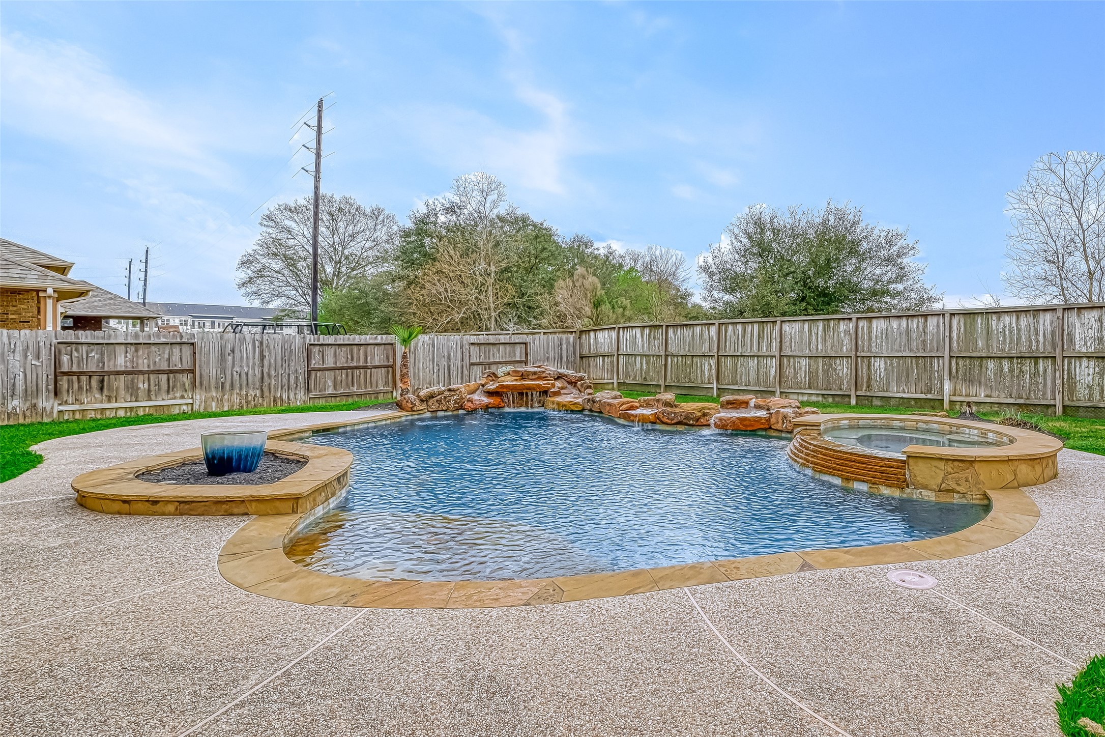 Enjoy the beautiful backyard with a pool, spa, rock water features and covered patio.