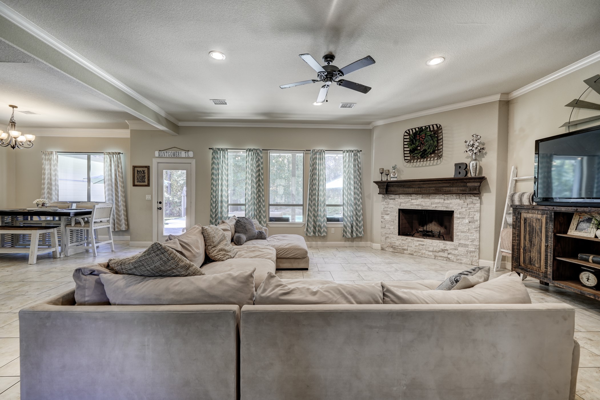 Open to the kitchen and dining room is a large comfortable family room. A gorgeous stone fireplace creates a nice accent while the wall of windows over a view of the pool and surrounding trees.