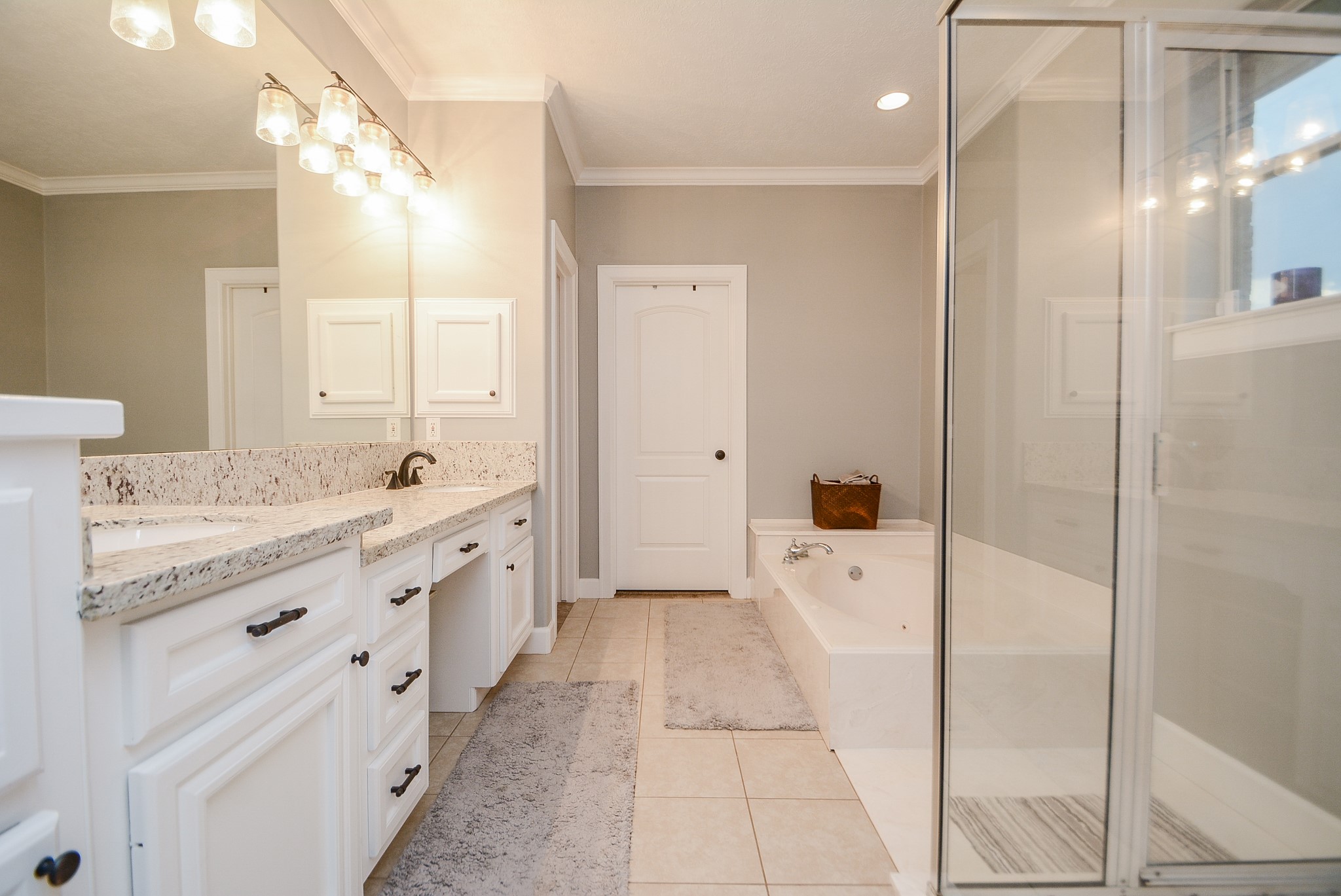 En-Suite Bath for the Primary Bedroom has Granite Countertops, Double Sinks, Whirlpool Bath, Separate Shower, Toilet Room, Large Walk-In Closet, and Linen Storage.