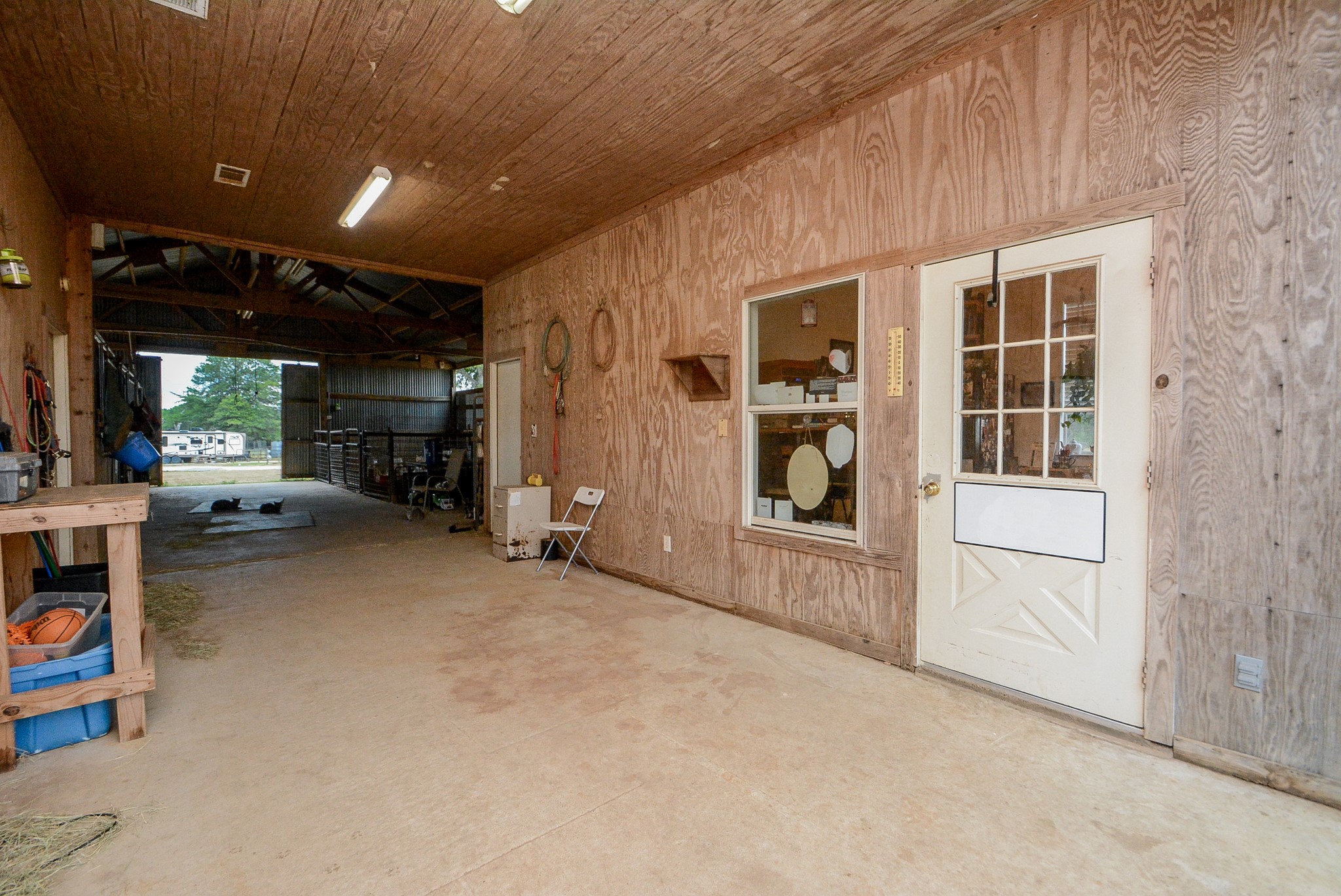 Inside the Barn/Stable are the Living Quarters. Behind the Half French Door is the 11x11 Kitchen with Upper & Lower Cabinets, Double Stainless Steel Sink, Electric Stove/Range, Refrigerator and Room for a Breakfast Table. The Room behind the Solid Door is the 11x11 Bedroom. Both Rooms have A/C.