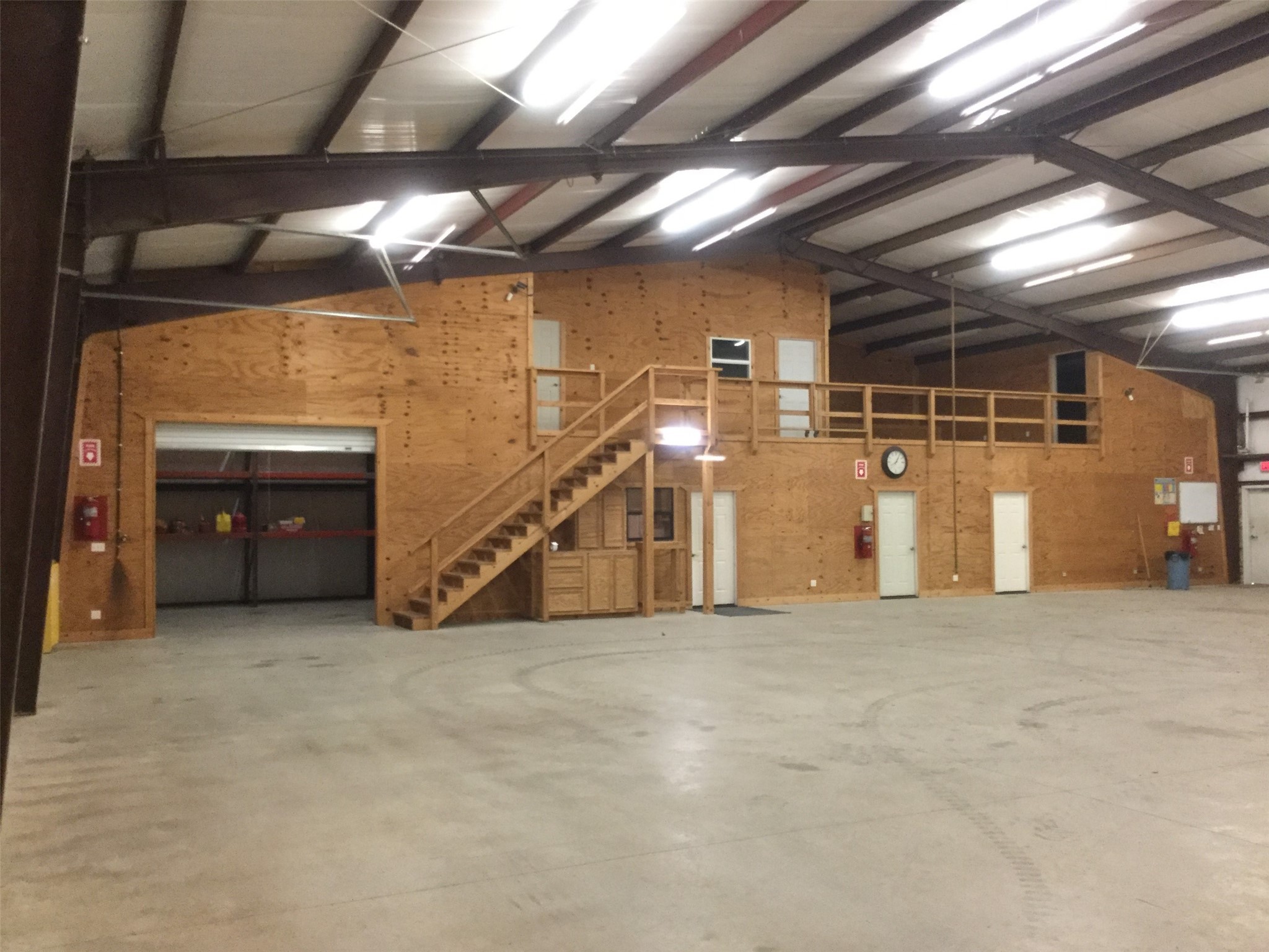 Exterior of 80'x60' warehouse/shop.  Three 16' overhead doors.  Office space is on the right side of the warehouse.