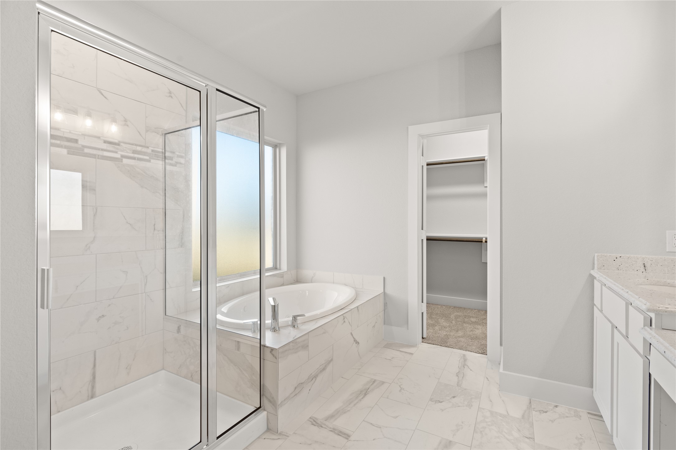 This additional view of the primary bath showcased the walk-in shower with tile surround and separate garden tub perfect for soaking after a long day.