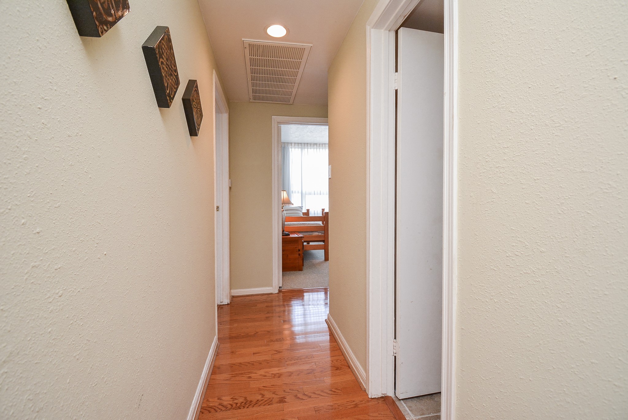 Hallway outside bedrooms and secondary bathroom.  Secondary bathroom is the open door to the immediate right.