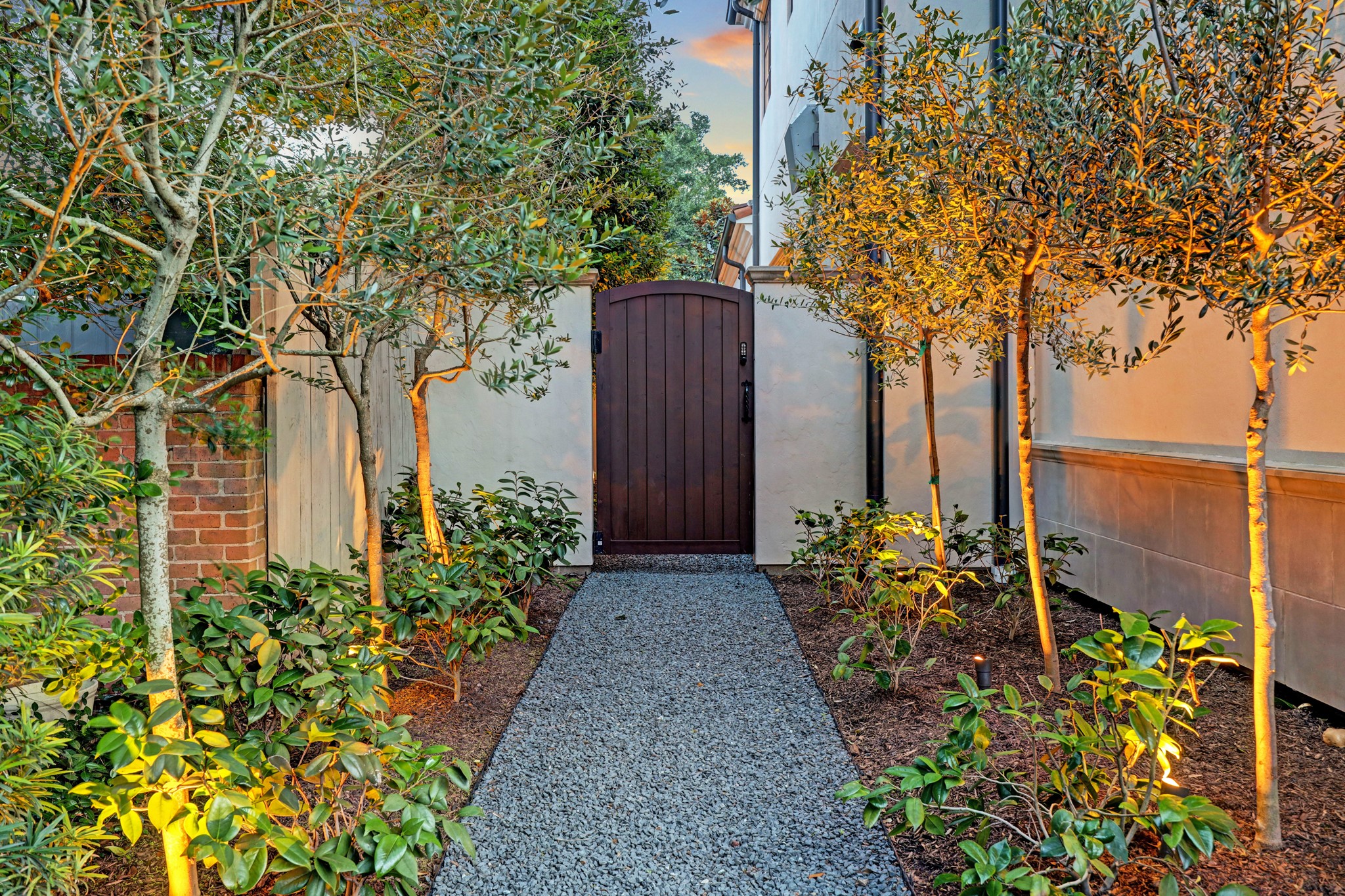 [Garden Gate]
This garden gate opens into the side patio with the standing water sculpture.