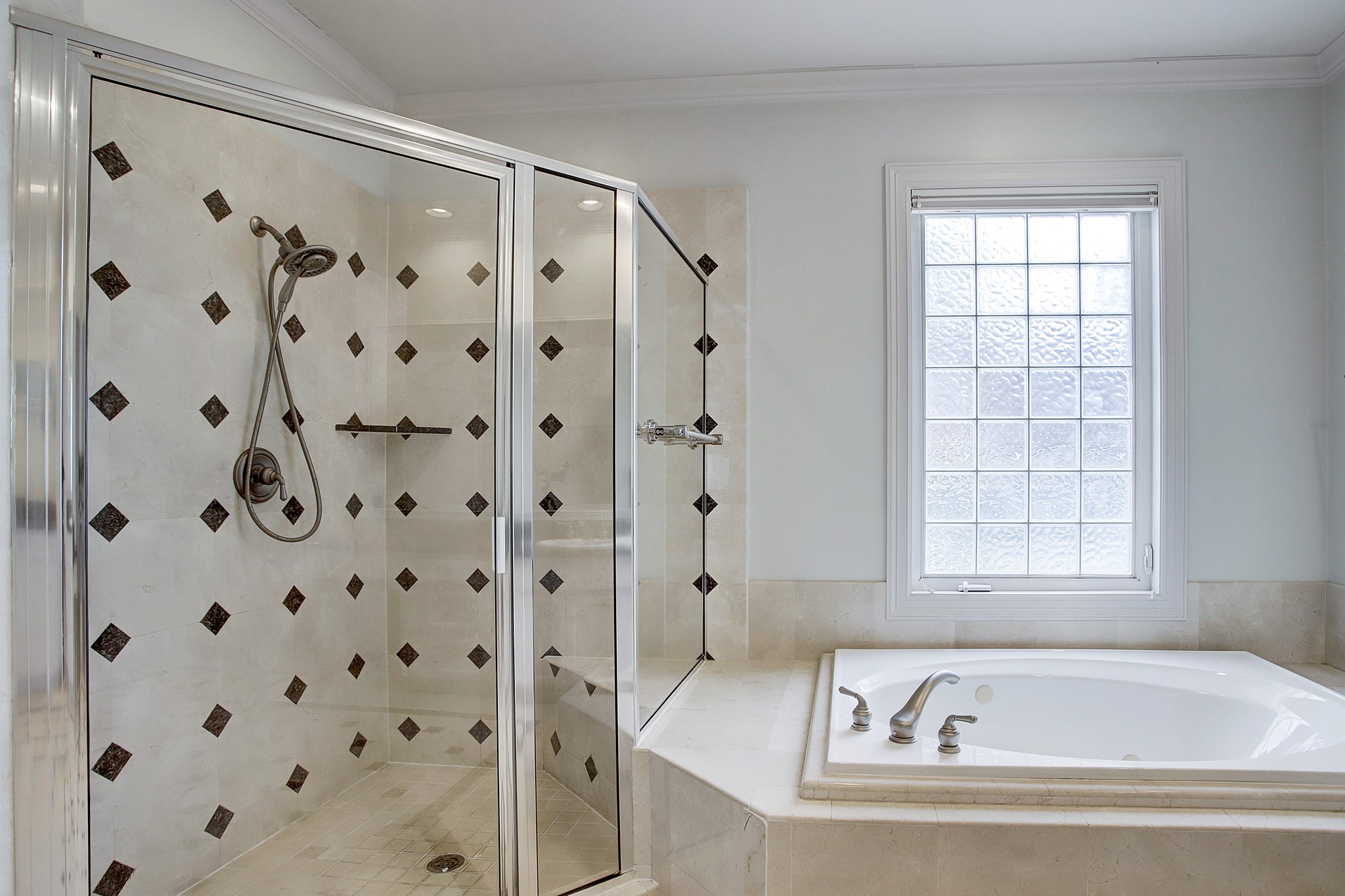 PRIMARY BATH - Light-filled primary bath features a jetted tub and separate shower.