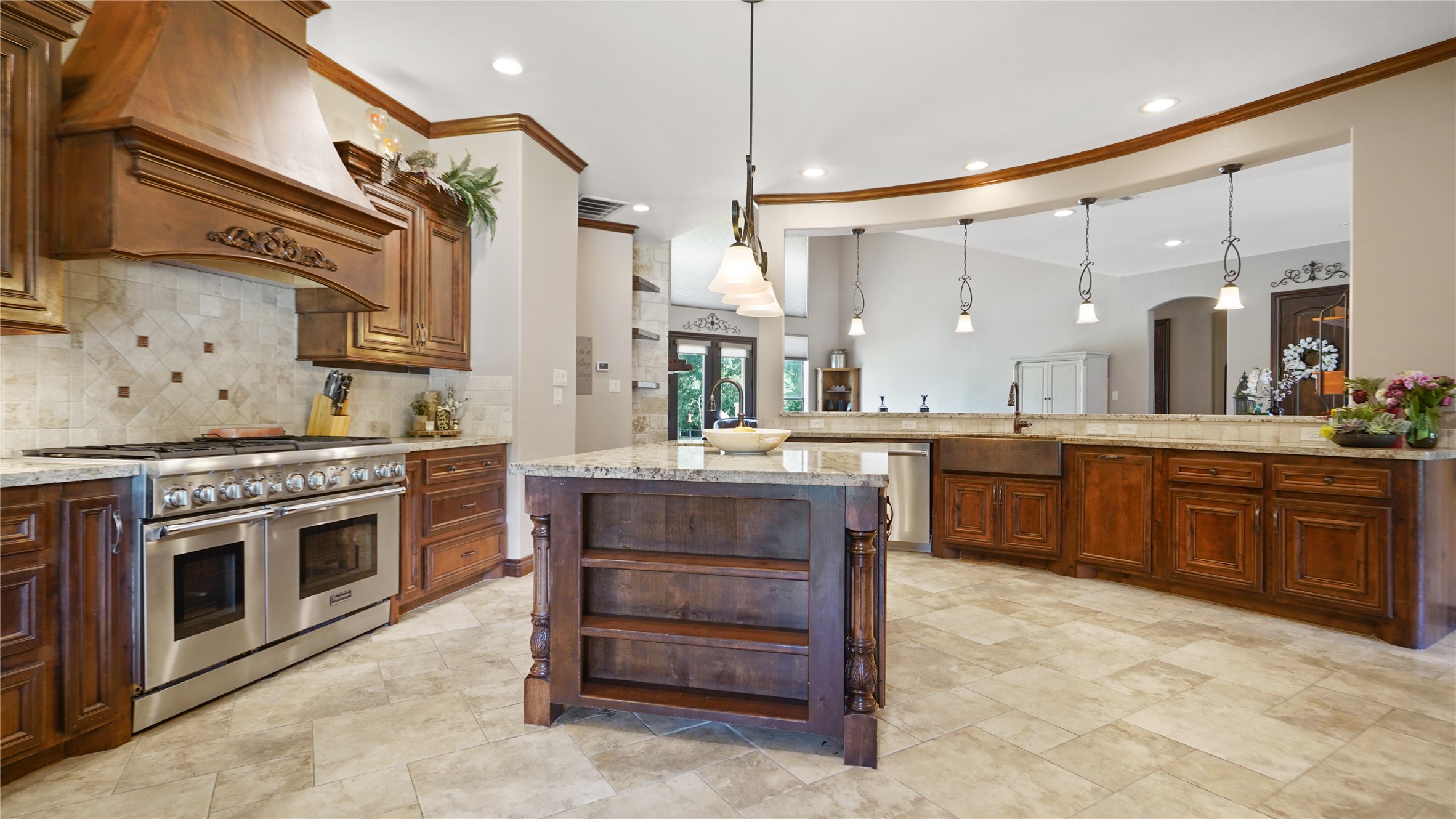 gourmet kitchen is a culinary masterpiece, adorned with luxurious granite countertops, top-of-the-line Thermidor appliances, a built-in fridge, and an exquisite copper sink.