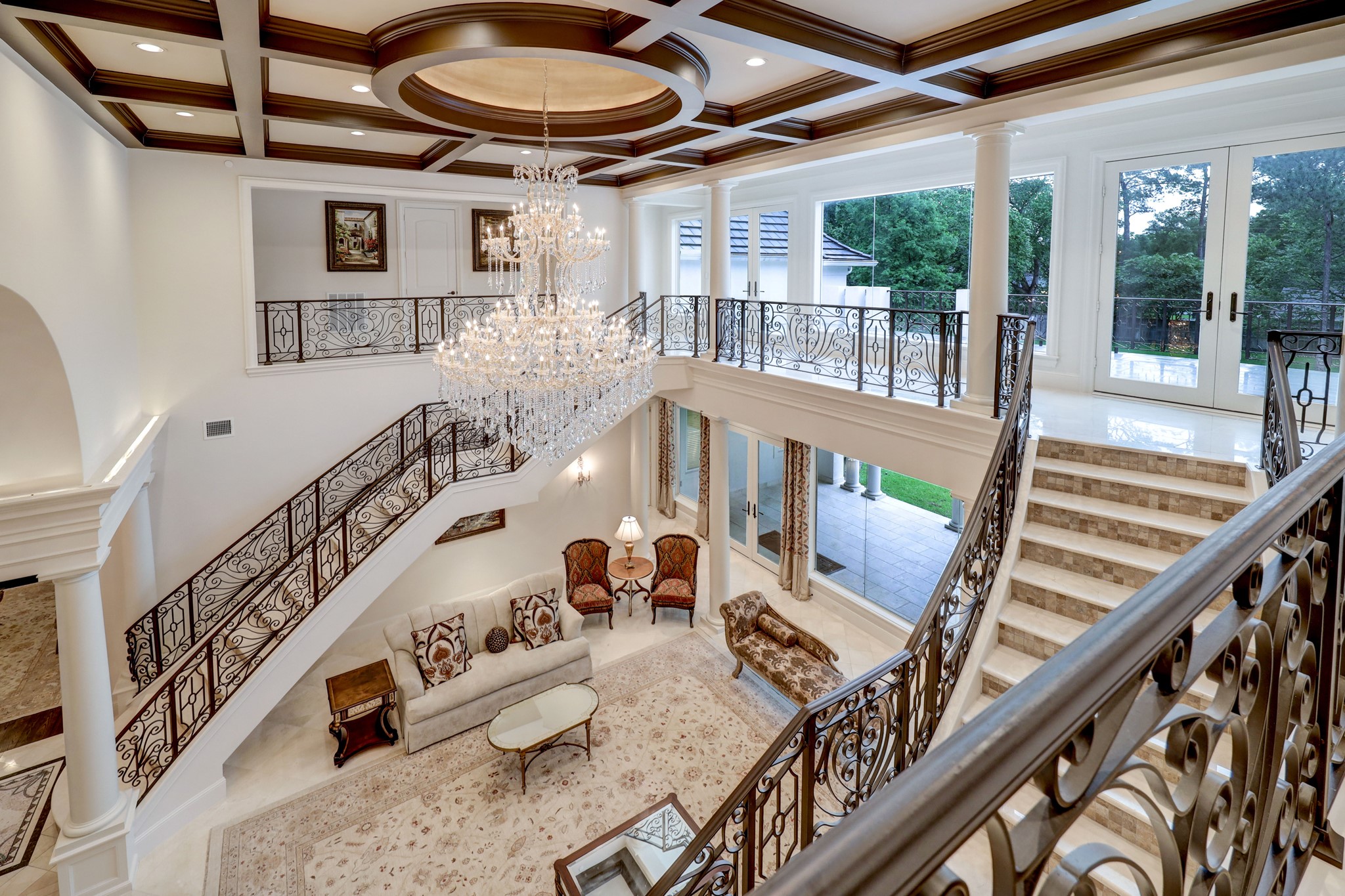 Check out the stunning views from upstairs looking into the Formal Living Room. The two-story ceiling and abundance of windows allow natural light to flood the house.
