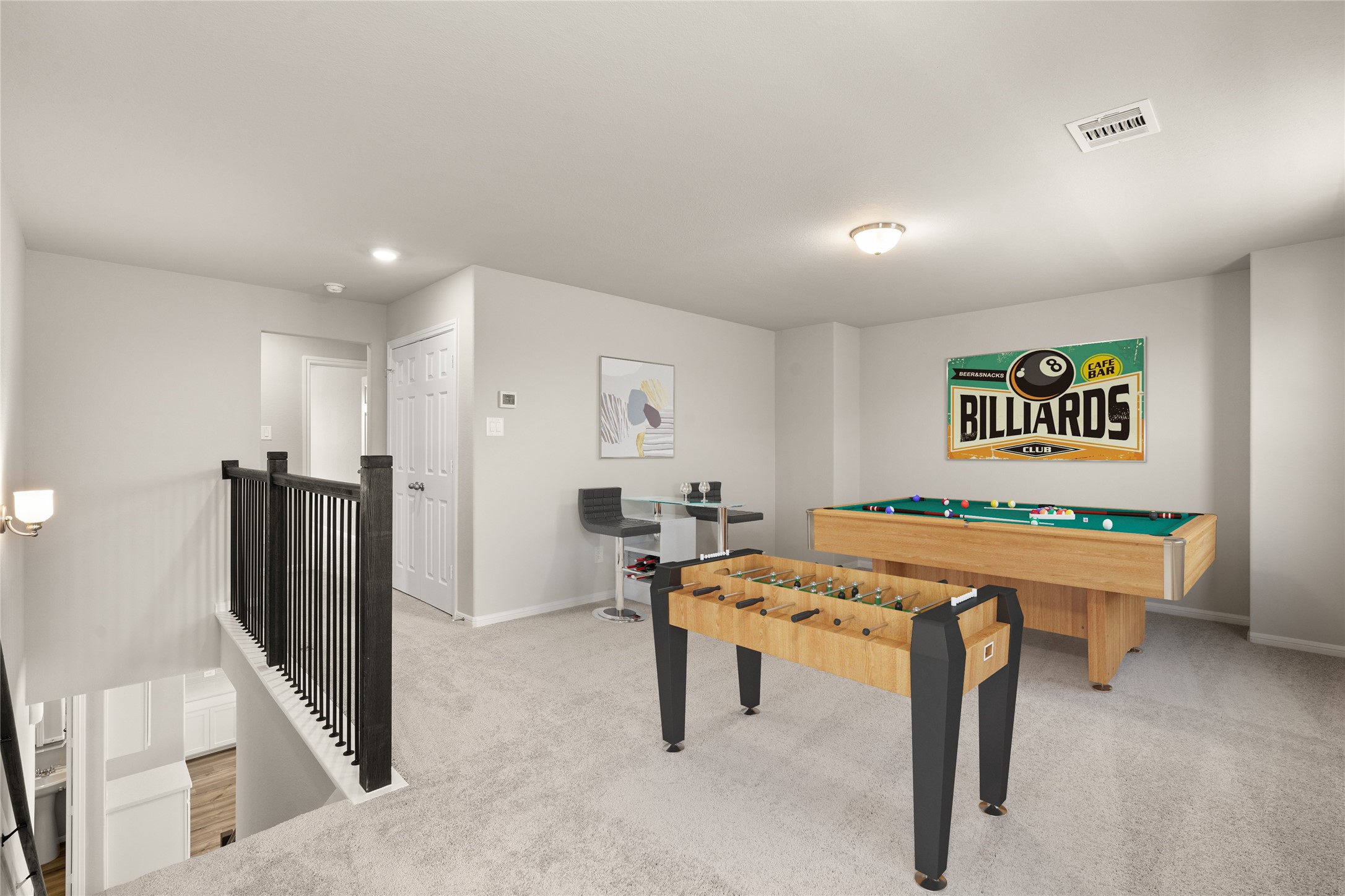 Come upstairs and enjoy a day of leisure in this fabulous game room! This is the perfect hangout spot or adult game room, this space features plush carpet, high ceiling, recessed lighting and custom paint.