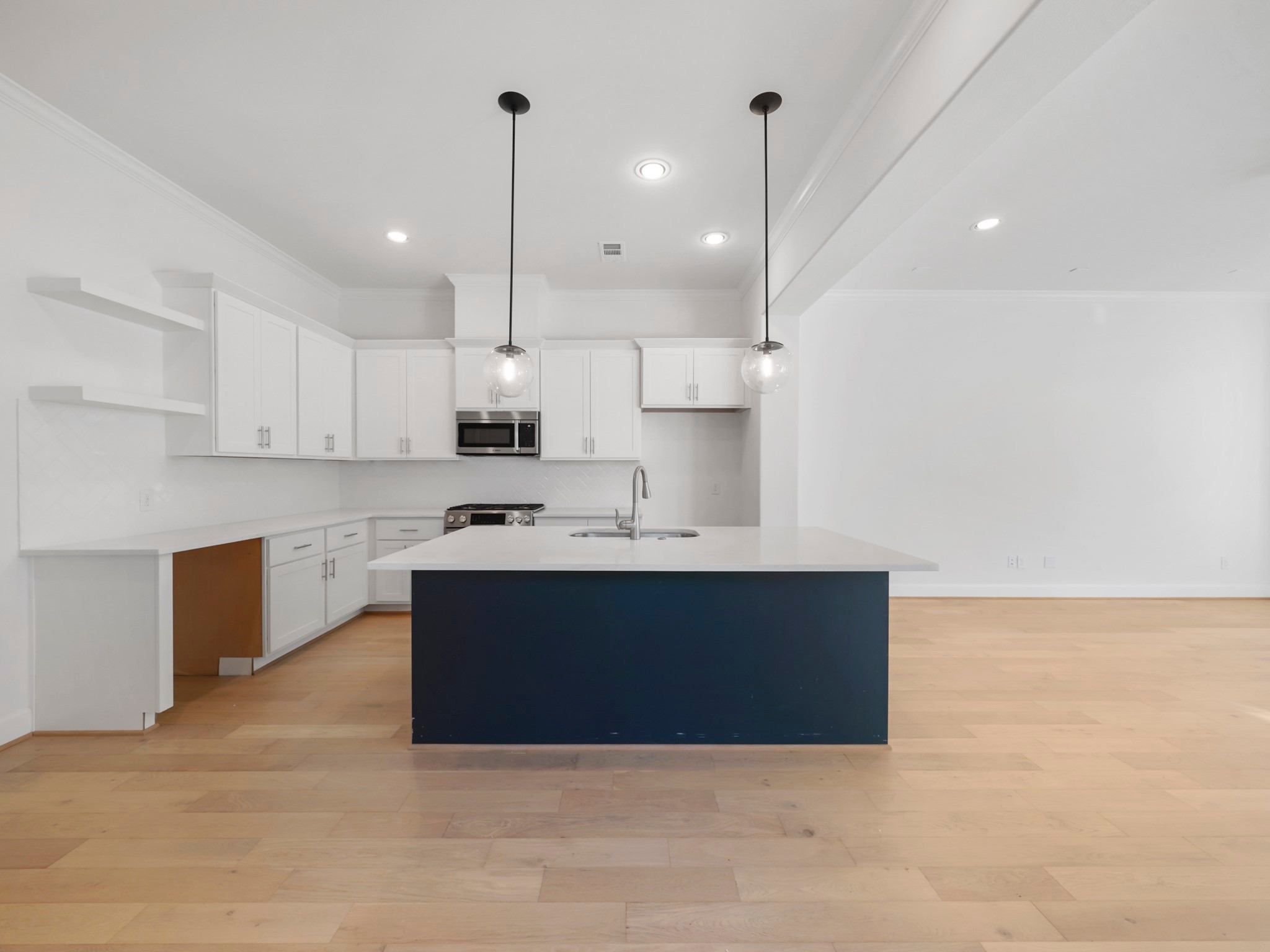 Step into 612 E.28th's kitchen—custom cabinetry & elegant floating shelves await your culinary inspiration!