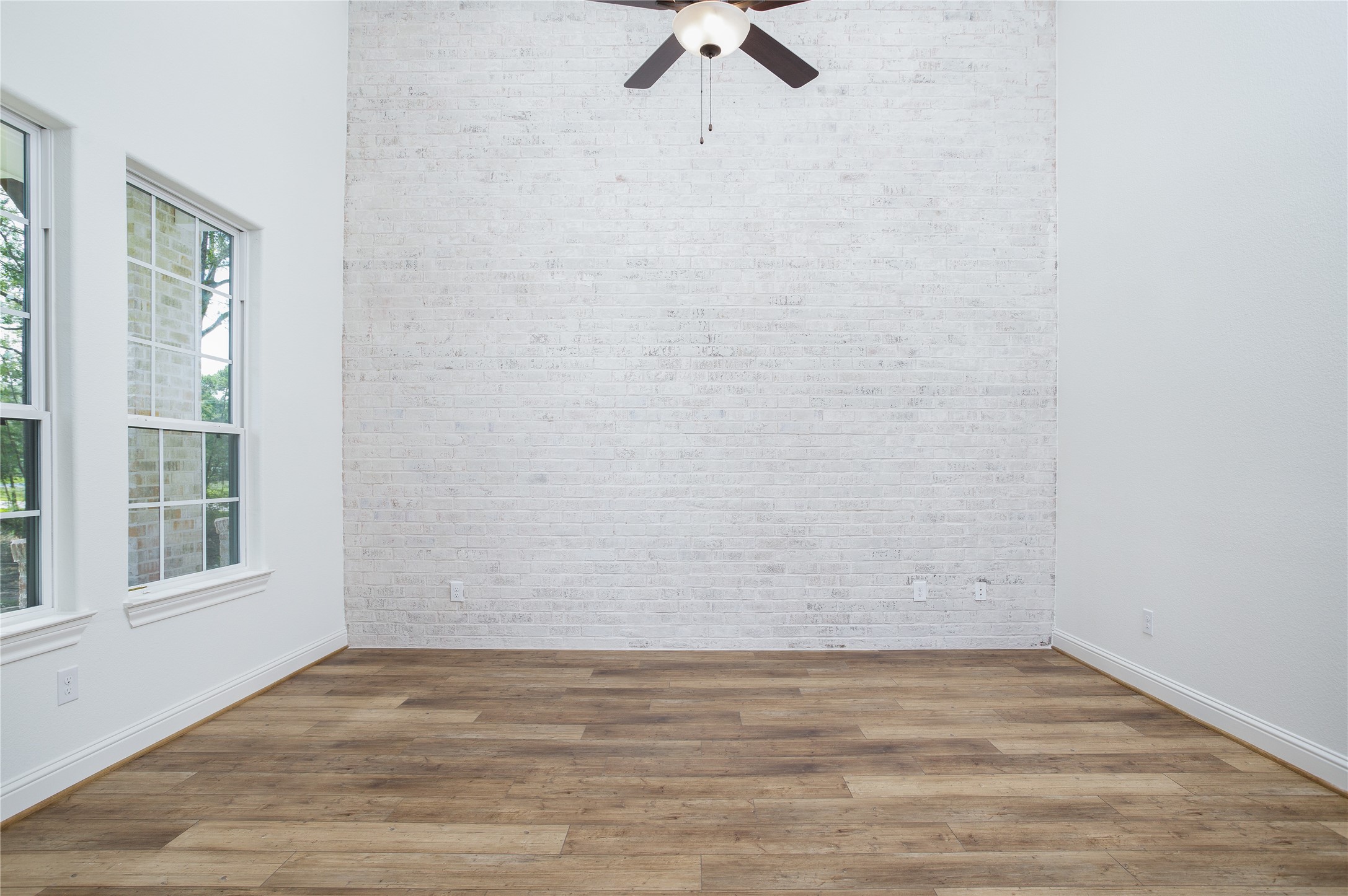 This room up front is perfect for home office/study.  Amazing floor to ceiling brick accent wall. HIGH ceiling.