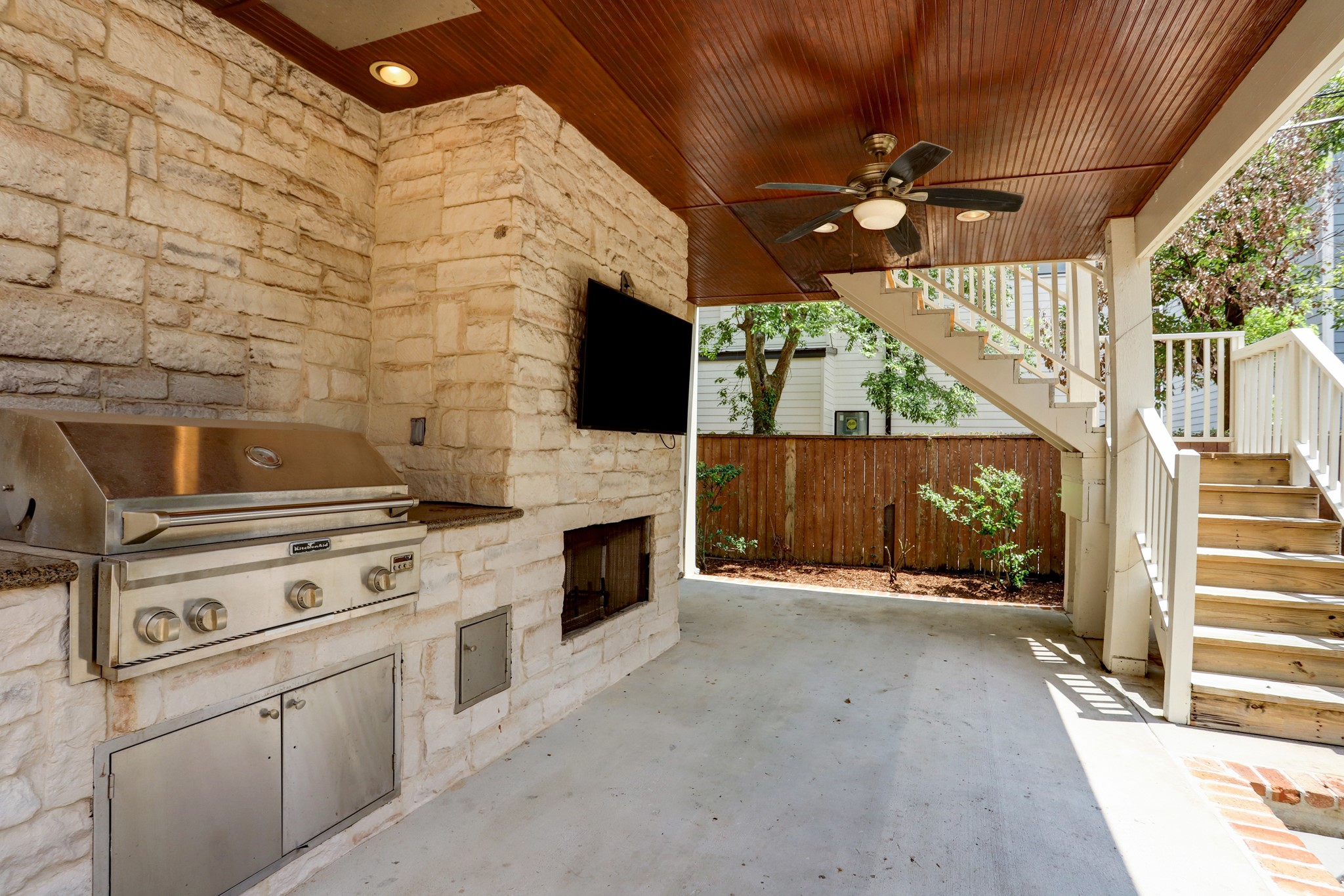 Perfect area for entertaining with a built-in gas grill, mounted tv and fireplace.