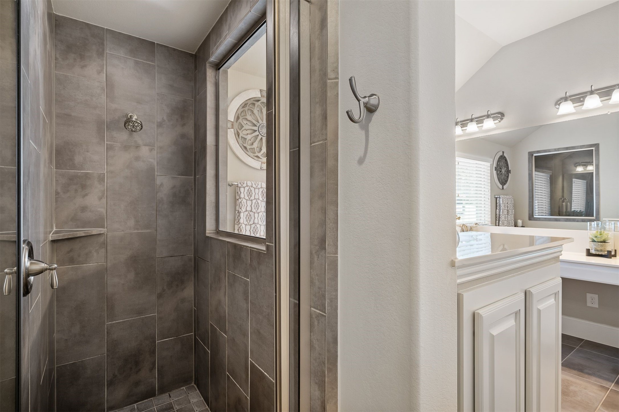 Walk-in shower with glass door and window to let in the natural light!