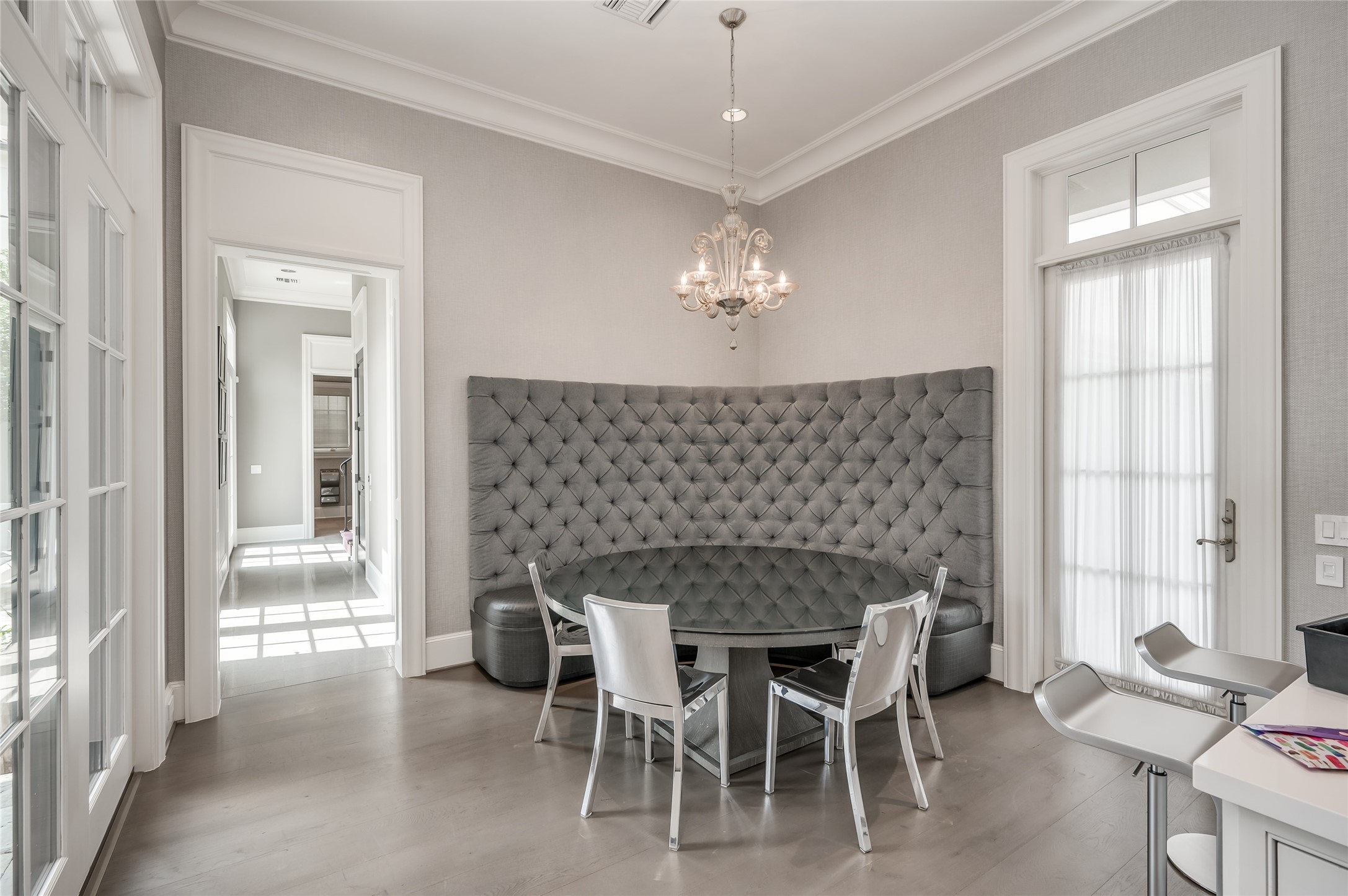 [Breakfast Room]
Open to the kitchen and family room, the breakfast area features a custom-designed upholstered banquette. Note service hall to return staircase, pool bath, and garage.