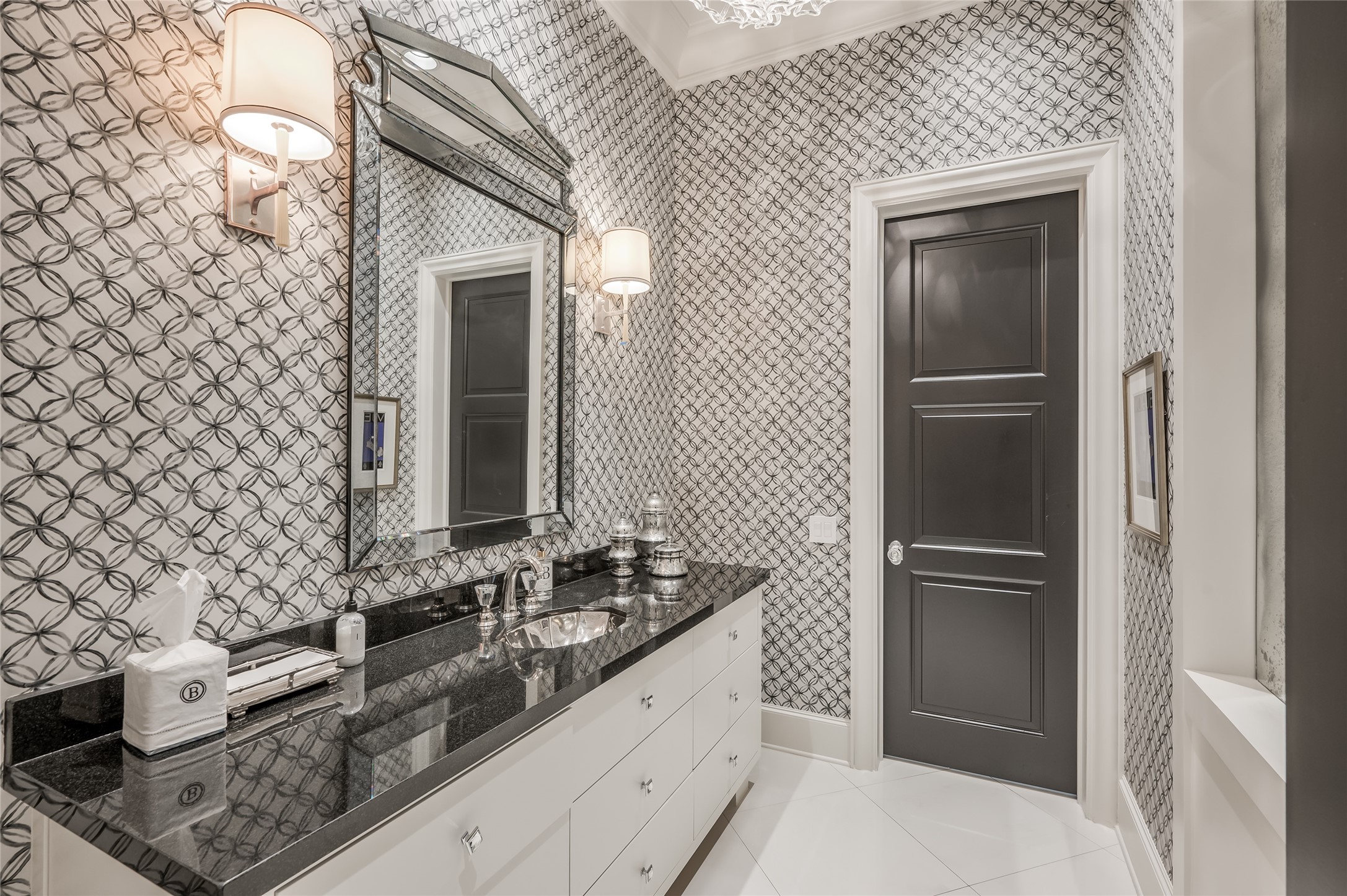 [Formal Powder Room]
Located in the cross gallery near the study, the formal powder room features designer wallpaper, a marble floor, granite sink deck, and a verre eglomise wall mirror (right).