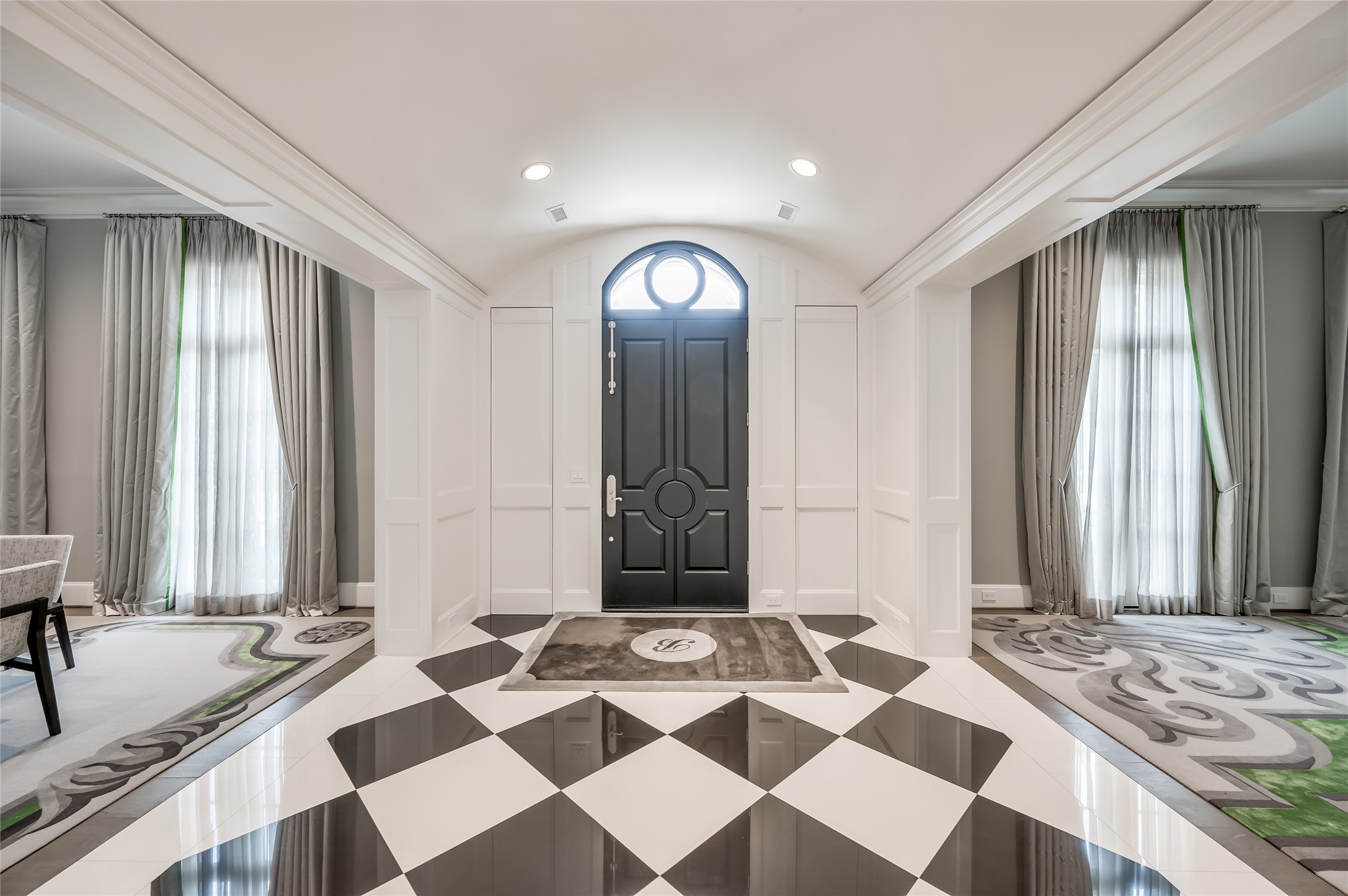 [Foyer]
Beneath a barrel ceiling, this stunning black and white marble floor makes a dramatic statement. Note dining room (left) and living room (right).