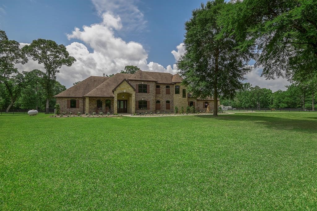 Incredible Equestrian Estate nestled on almost 8 acres with mature hardwoods.