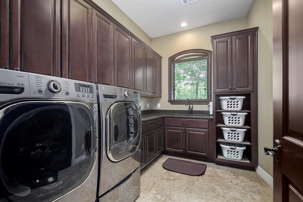 Well designed utility room with sink and shelving for baskets.