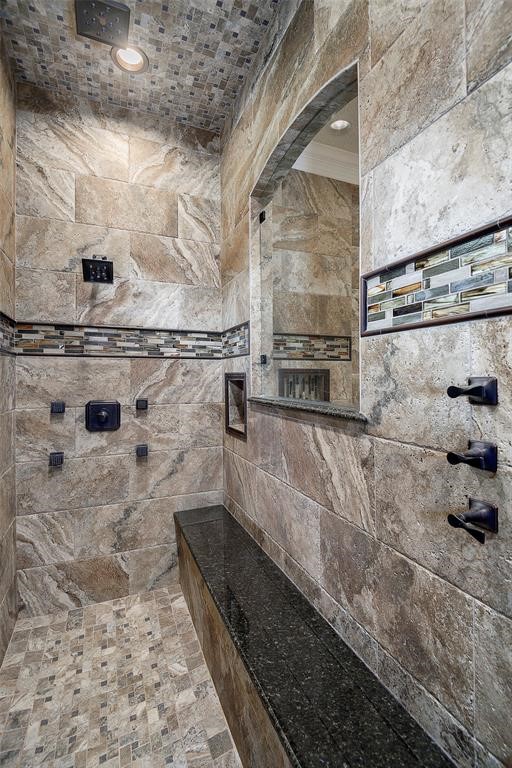 Amazing master shower with bench, gorgeous tile work, rain head and body spray.