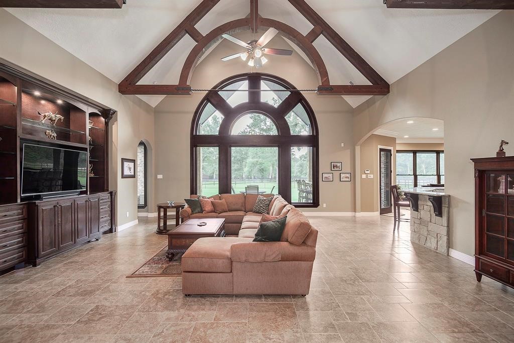 Vaulted ceiling in the main living room with ceiling beams. The home has Pella windows throughout.