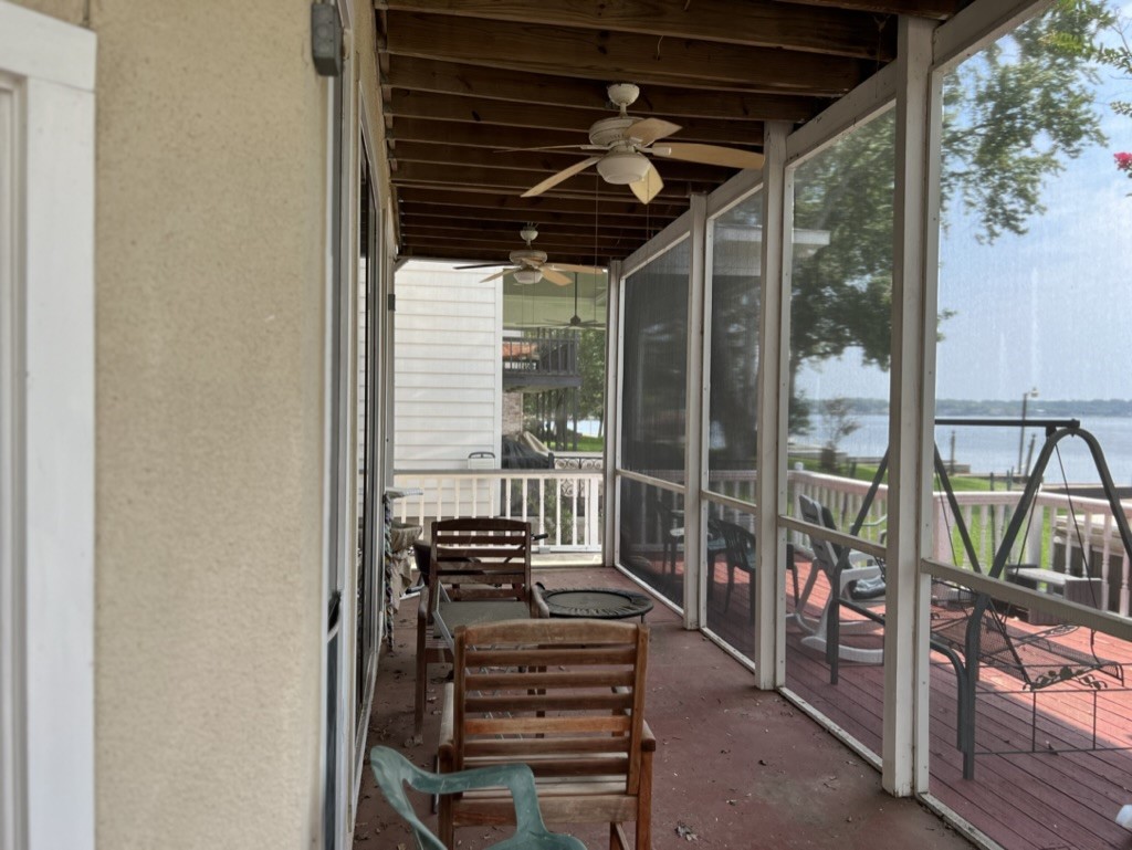 Screened in porch with a beautiful view of Lake Conroe