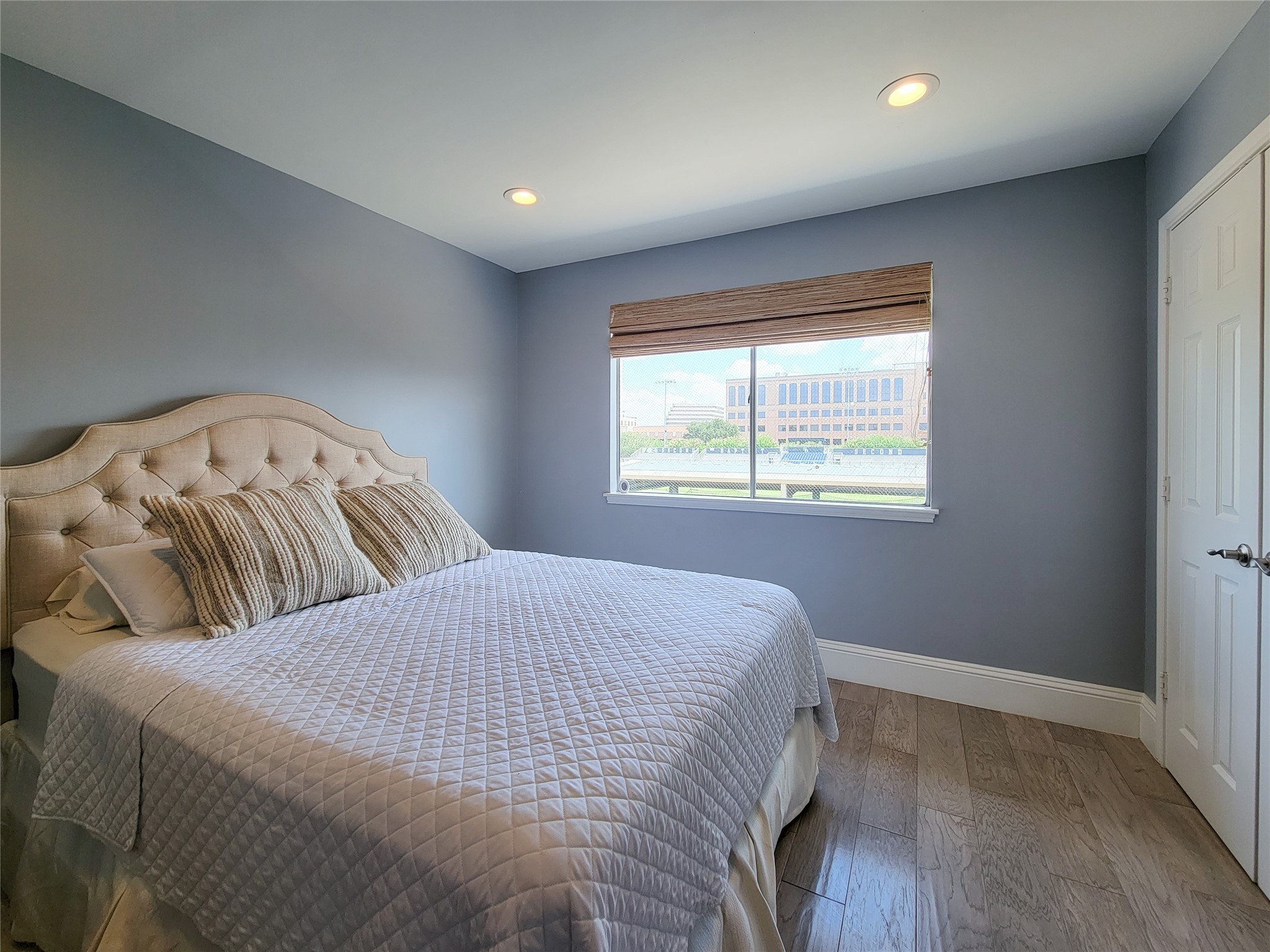 The secondary bedroom is quite spacious and also has a lovely view. Note the wide designer baseboards throughout the home.