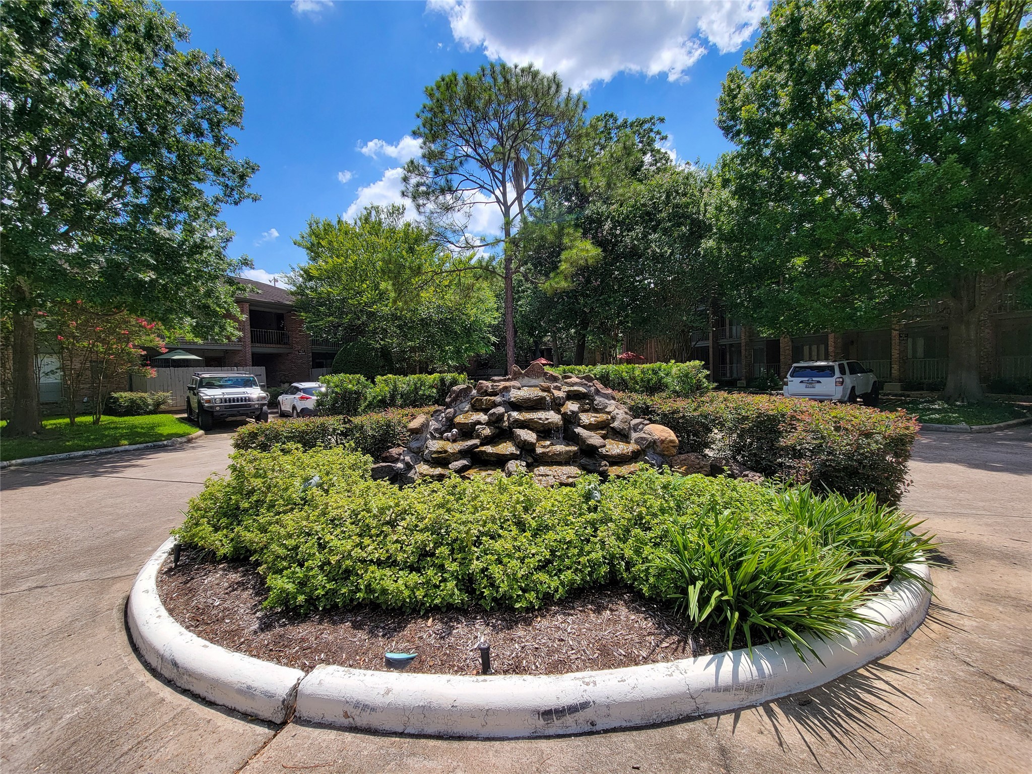 Lovely landscaping touches like this fountain in a roundabout just in front of the building. There is quite ample visitor parking near the unit.