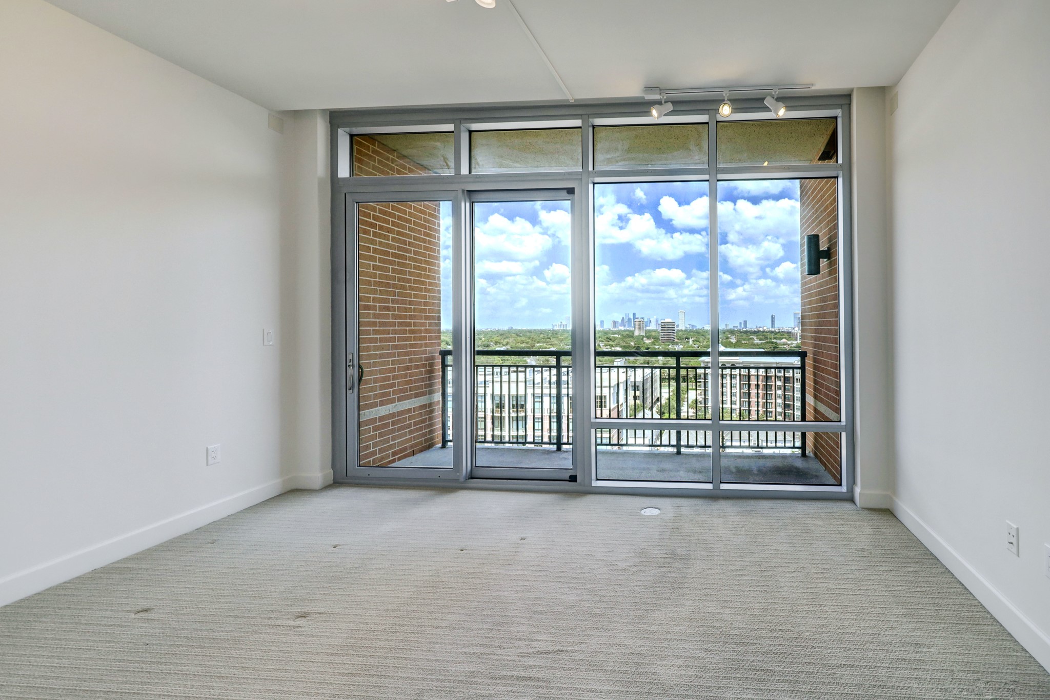 The second bedroom with ensuite bath enjoys the second balcony overlooking downtown Houston.