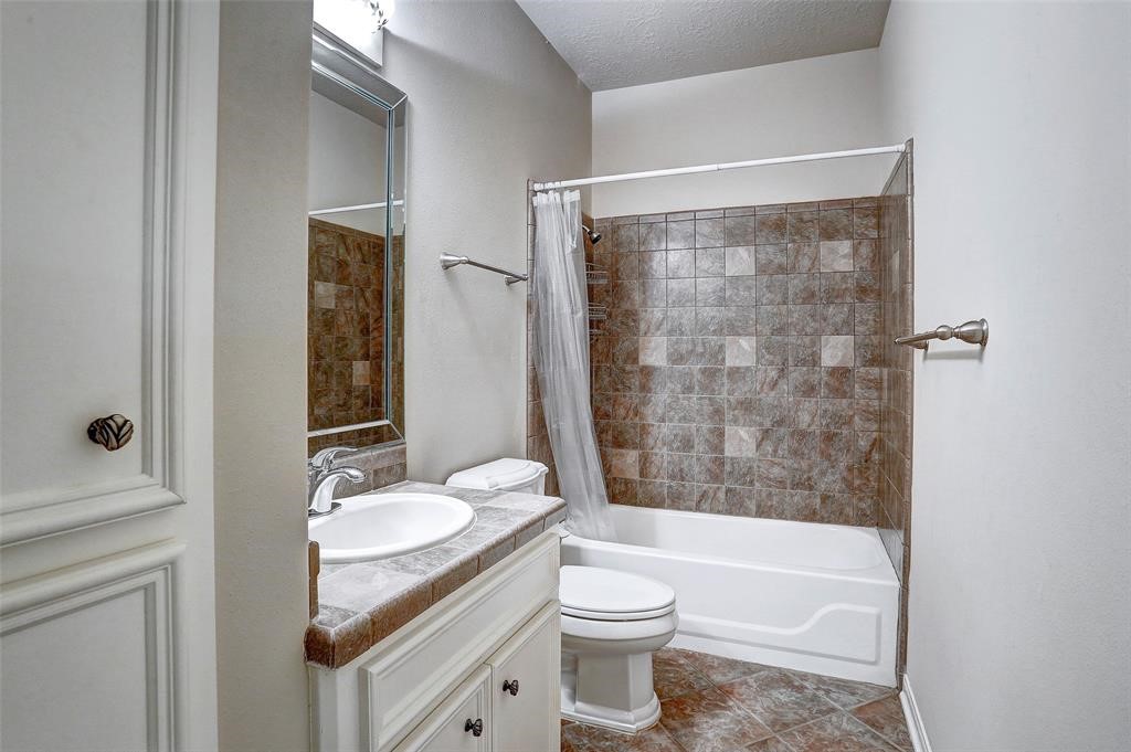 Upstairs secondary bath with tub and shower head serves bedrooms 2 and 3.