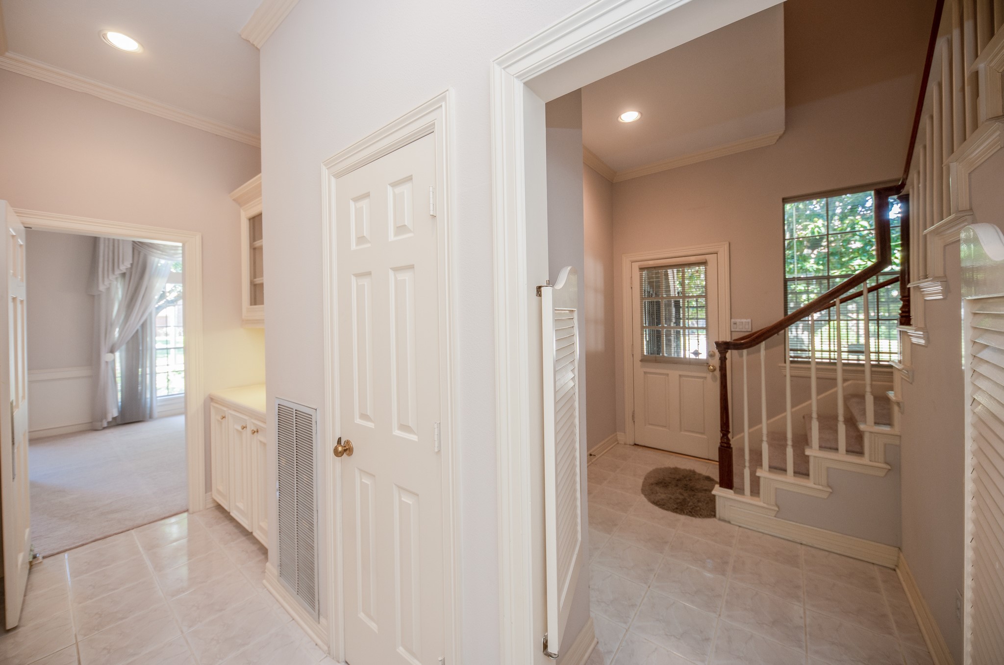 View of butlers pantry and side door with easy access to laundry room and back stair case. Convenient when carrying in groceries.