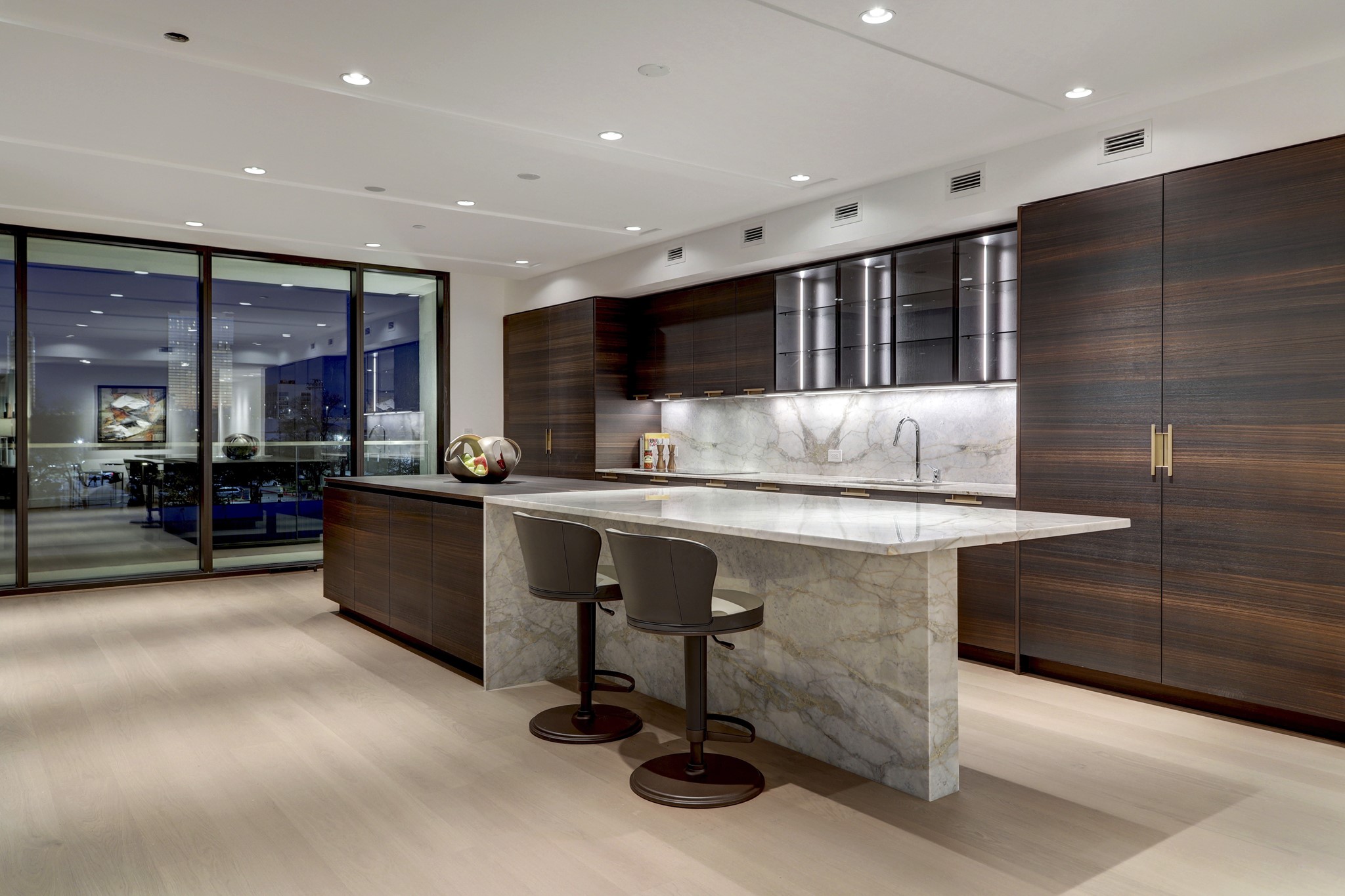 Wrought from rich wood and stunning marble, the primary kitchen's massive center island provides dedicated space for serving, casual dining and stimulating conversation.