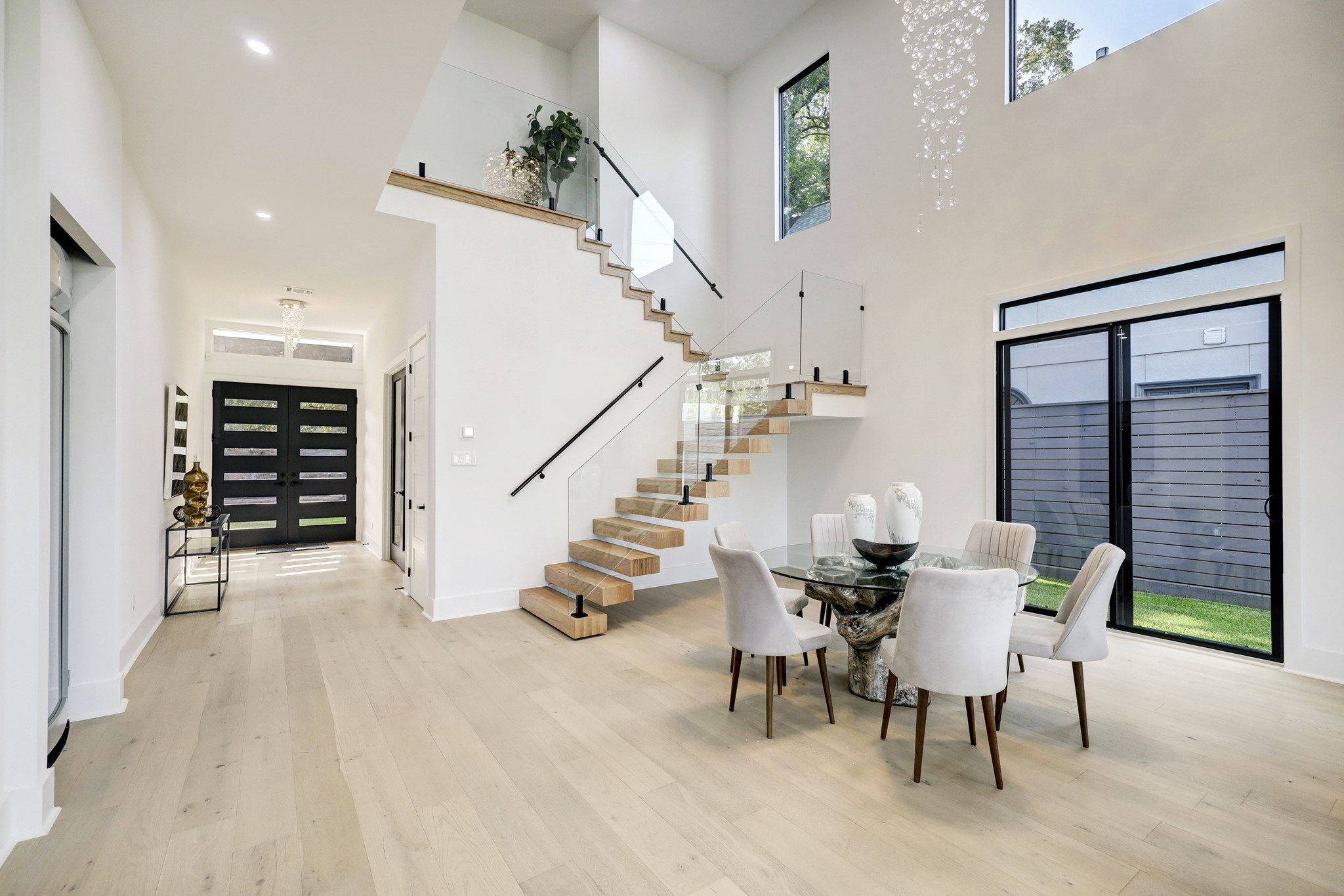 Soaring ceilings with elegant lighting and fans, soft natural light from oversized windows, beautiful flooring, and other stunning contemporary details throughout make this the one to call home.
