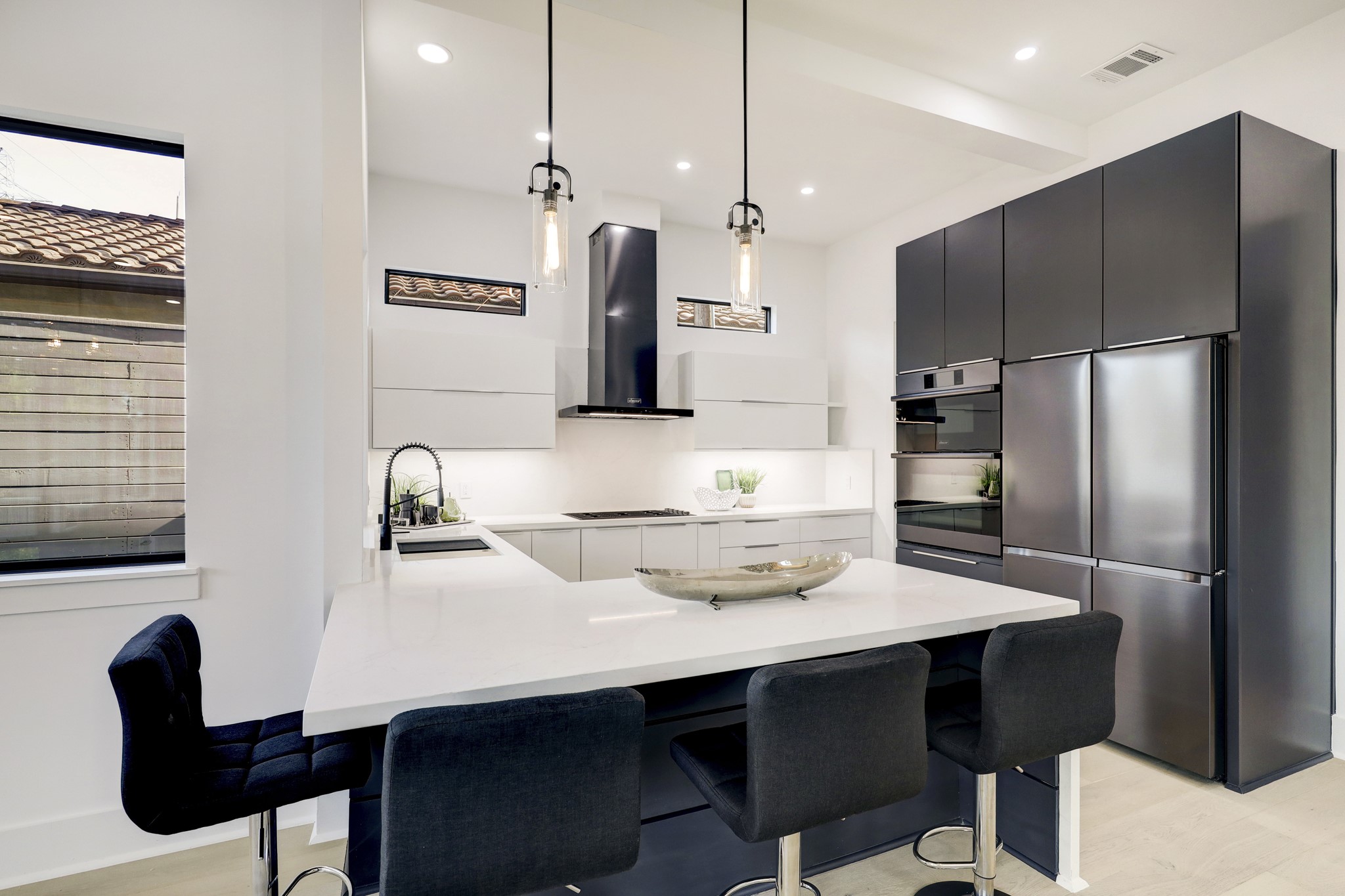 This spectacular kitchen is ready for you to show off your culinary skills. Find gorgeous Calacatta Quartz countertops and backsplash with under-cabinet lights, custom cabinetry with soft close features, high-end Decor appliances, a butler's pantry, incredible lighting and more.