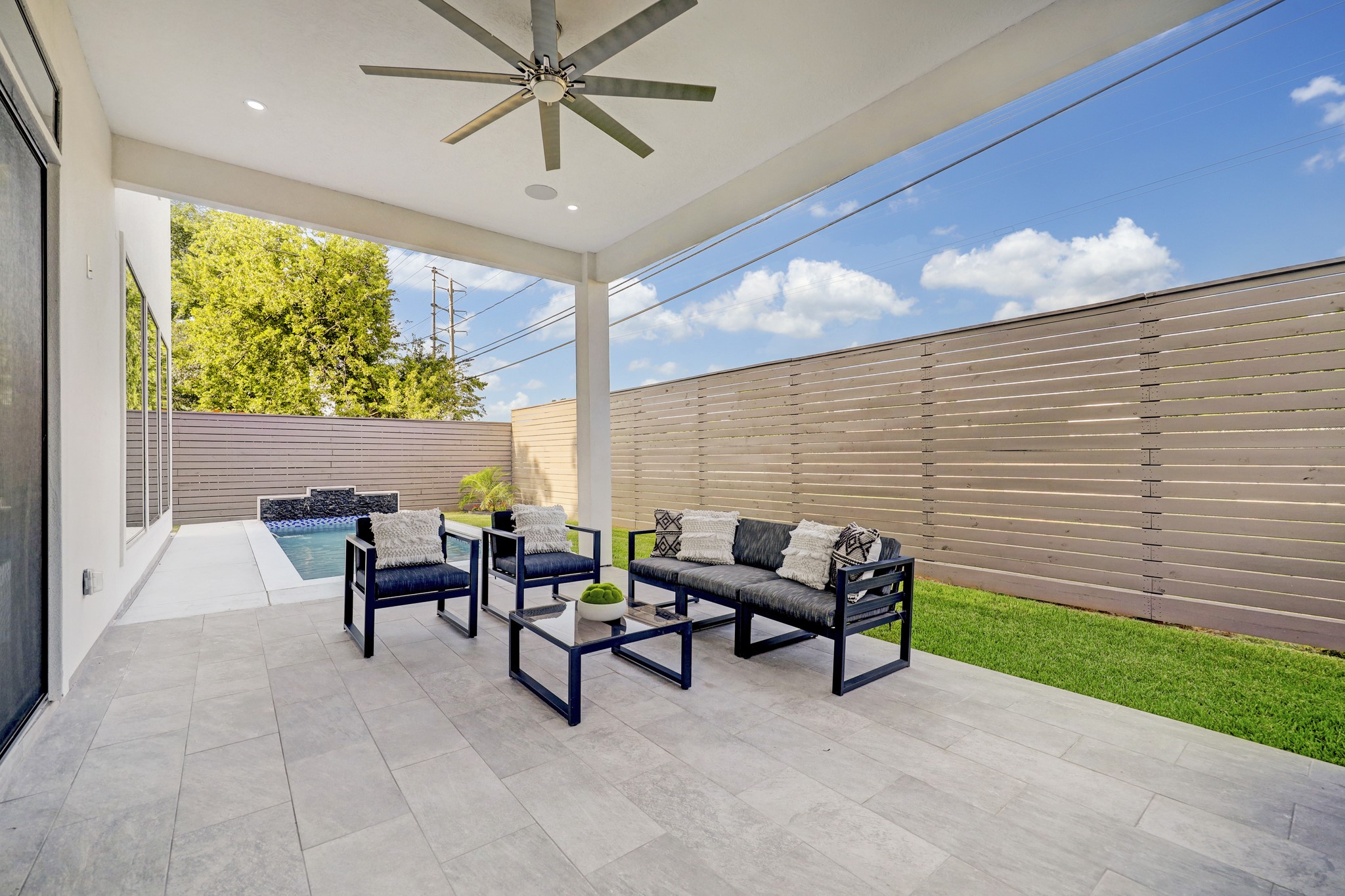 Indulge in poolside dining on the inviting covered patio, complete with a full summer kitchen.