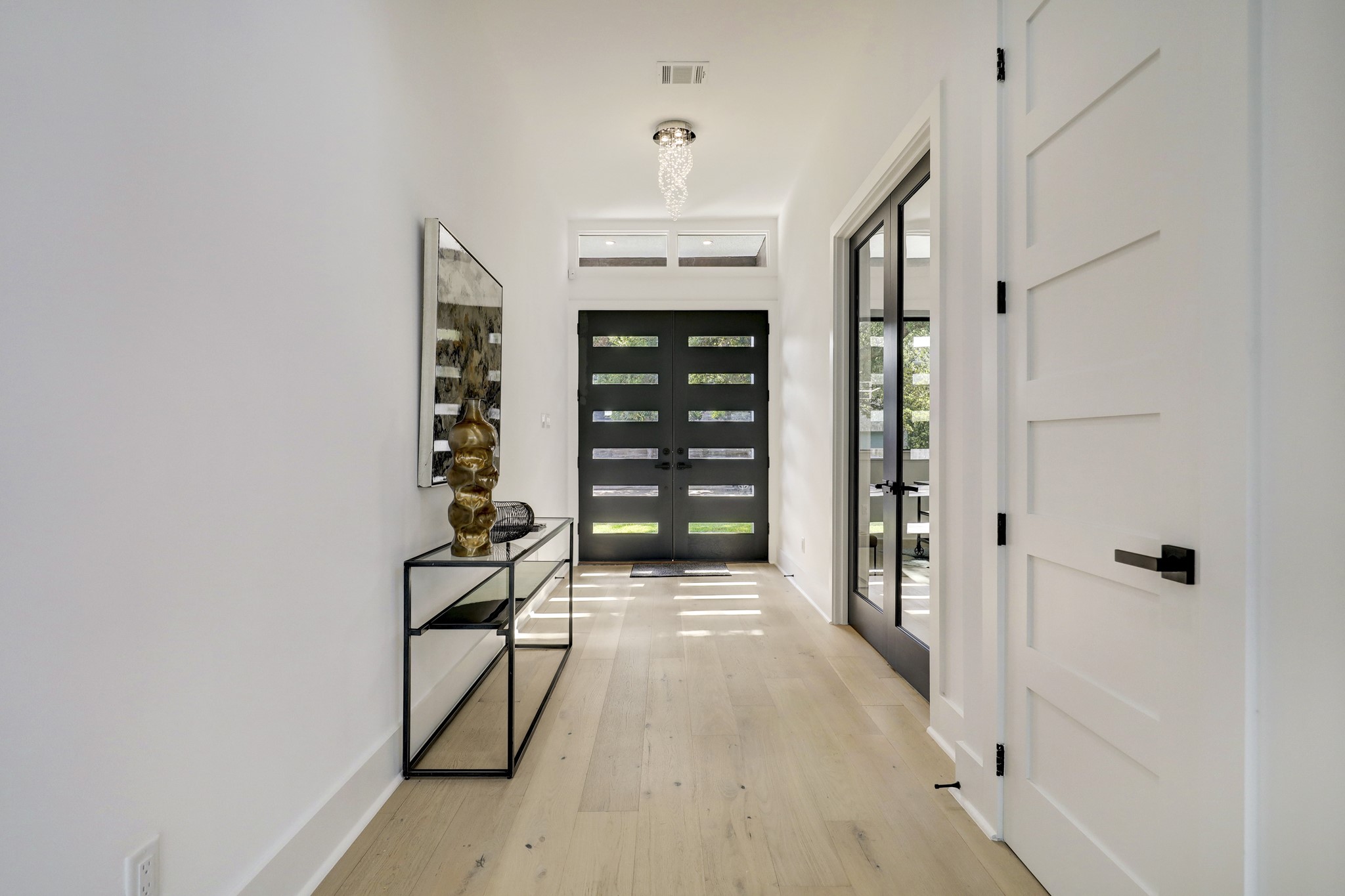 Step through the oversized modern doors for a preview of the exquisite details and contemporary finishes that fill this home the front door to the back.