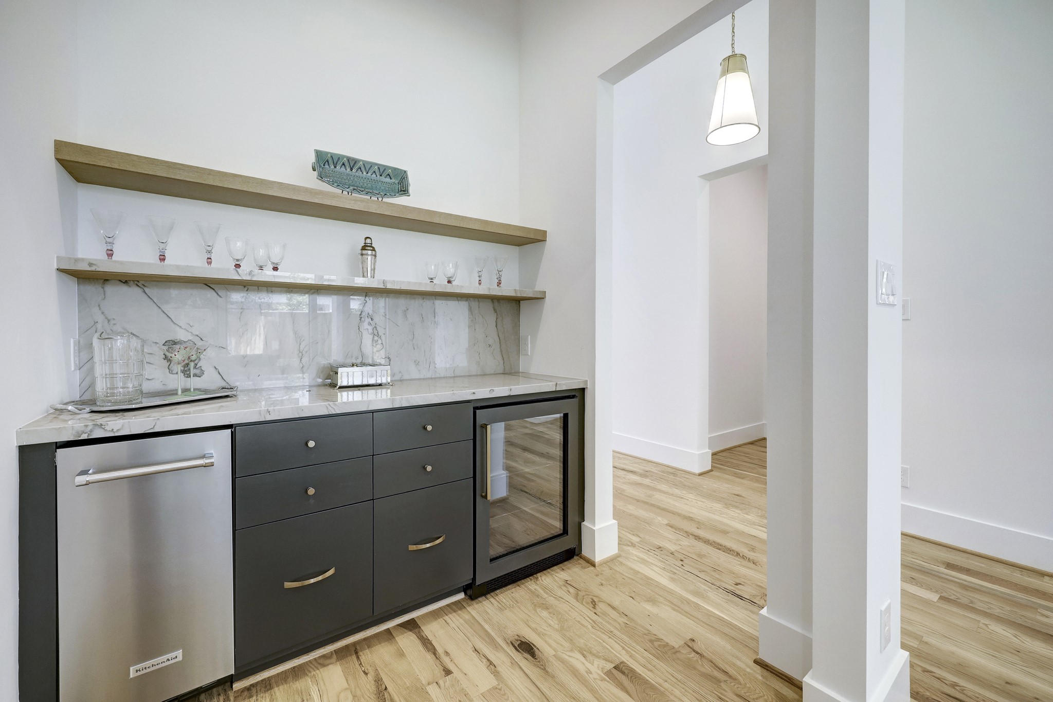 Dry bar off of great room with ice maker and beverage refrigerator