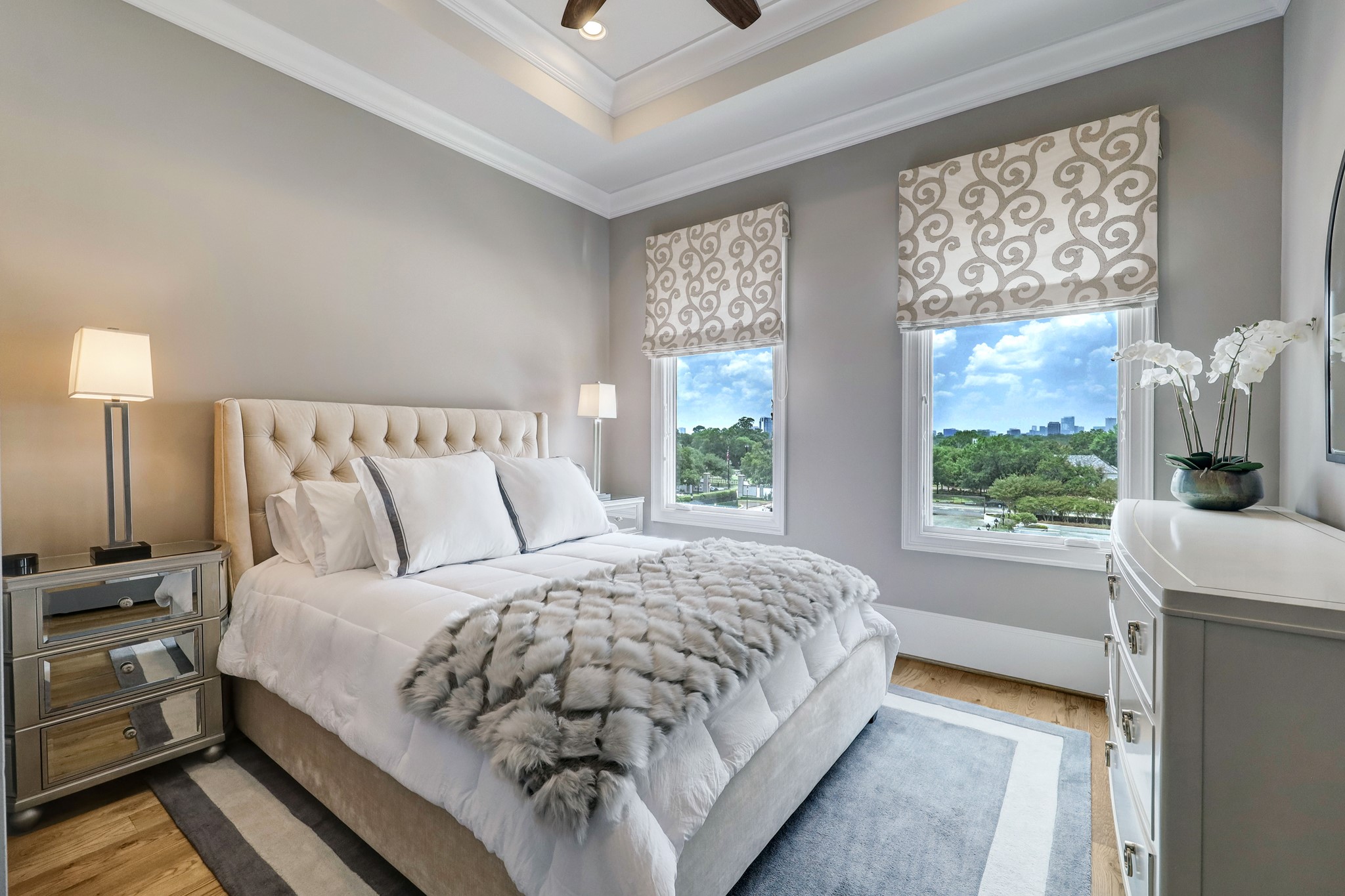 This secondary bedroom on the fourth floor features crown molding, spacious closet, large windows, and access to the game room.
