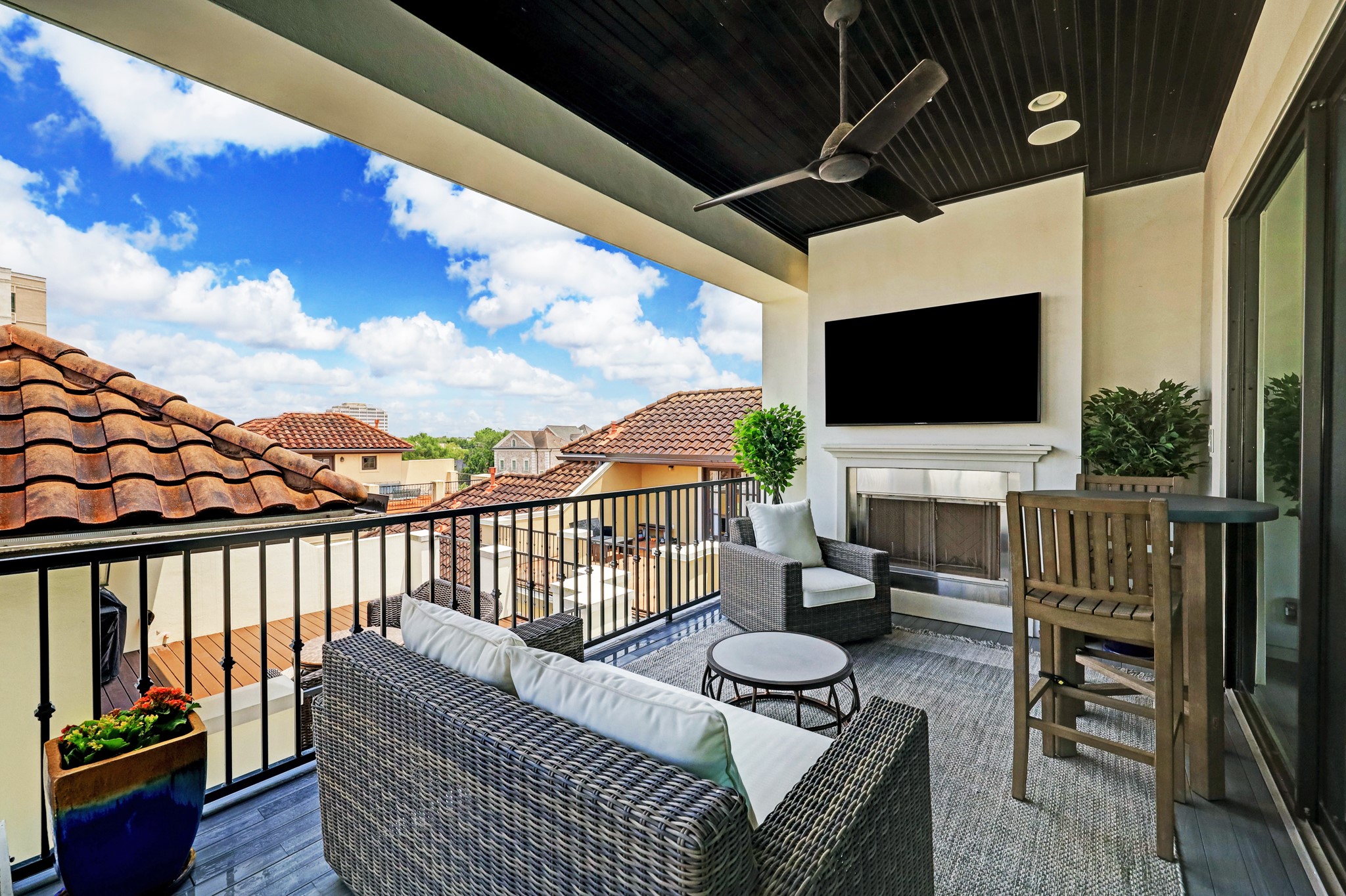 The outdoor patio features a fireplace, ceiling fan, and a built-in grill.