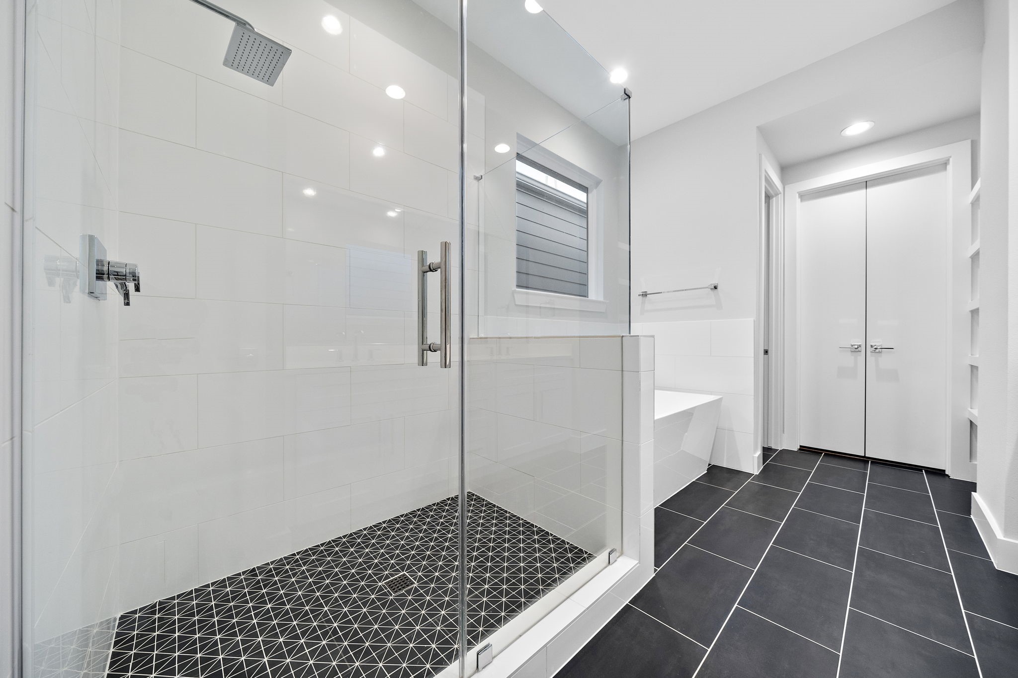 Gorgeous tile in the primary bath. Walk in shower and a soaker tub with a window for natural light.